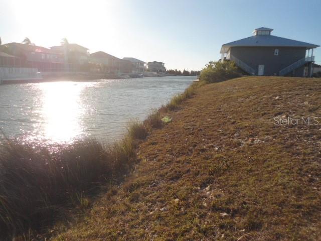 Waterfront lot located in deed restricted Hernando Beach South. Lot is located on the south side of the street which means you will have the afternoon sun in your backyard when you build. Come build your dream home in this waterfront community of upscale homes with boat access to the Gulf of Mexico. The yearly HOA fee includes the grass cutting of the lot until you build.