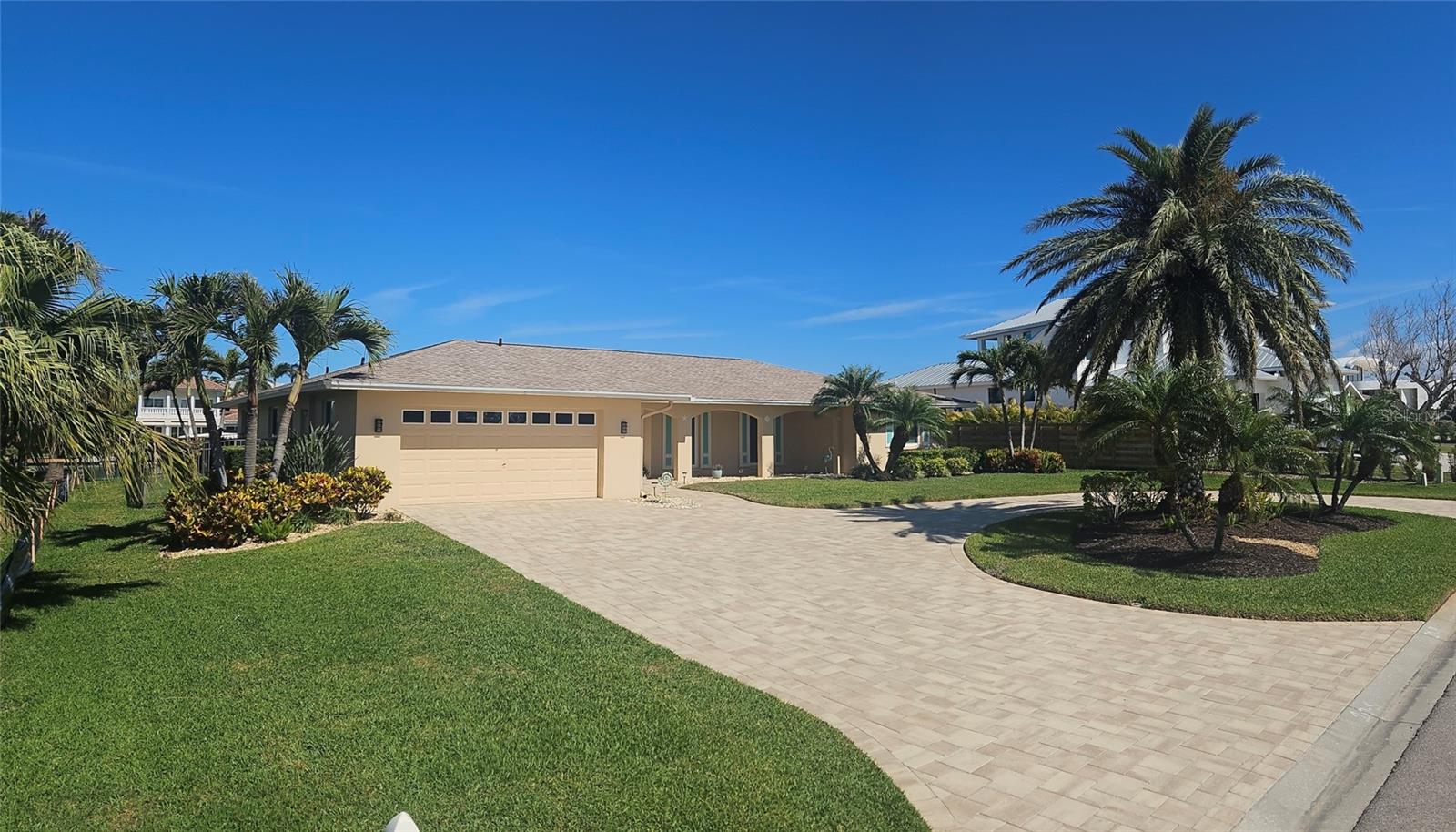 This house had no flooding after major hurricanes of 2024 due to its high elevation and hurricane resistant doors and windows.  Assumable loan available. Coveted lifestyle and location in Emerald Harbor on one of the widest canals on Longboat Key with direct access to Sarasota Bay with no bridges. Move in ready and fully furnished. New roof 2024, new heat pump and spa 2023 and outdoor pool/lanai lighting.  50 foot dock and 10,000 lb boatlift with 100 feet of seawalled waterfront. Dolphin and manatees are rugularly seen in canals.  Meticulously maintained and beautifully landscaped. A spacious open floor plan with 3 bedrooms, 2 full baths and 1 half bath.  There is a gorgeous pool and spa ready for immediate enjoyment.  The split bedroom floor plan features sliding glass doors in the master suite, living room and dining room and kitchen opening into the screen enclosed lanai and pool.   Renovated kitchen -quartz countertops cabinets and new appliances, new bathrooms, travertine flooring, recessed lighting and freshly painted interior. Seawall, lift and dock were installed in 2017, pool and front pavers completed in 2018. Emerald Harbor is a quaint and desirable lifestyle. It is only a 5 minute walk to beach. The HOA includes a deeded beach access path. Everything in the house conveys except some select art decor. Aerial views were taken prior to new next door construction.