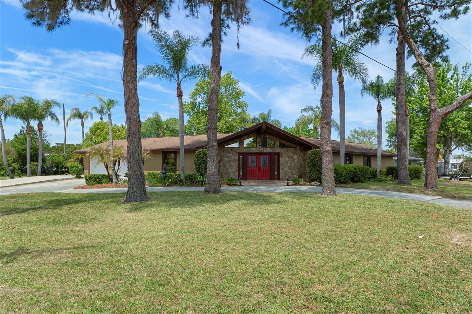 This waterfront home offers an impressive array of features. It is located on a freshwater large corner lot, providing ample space with a circular driveway for easy access and extra parking pad for additional guest. The home includes a refreshing salt water pool with screened enclosure and a sunroom that allows for plenty of natural light. Home has travertine tile throughout, step-down living room, three bedrooms and two baths, it is well-suited for family living or entertaining guests. Additional highlights include a wood-burning fireplace for cozy evenings, boathouse with lift and a floating dock, perfect for boating enthusiasts or for launching your Kayak. This property combines comfort and functionality in a stunning waterfront setting, located close to downtown Crystal River's restaurants and shops which are only a golf cart trip away. This one you will want to see!!