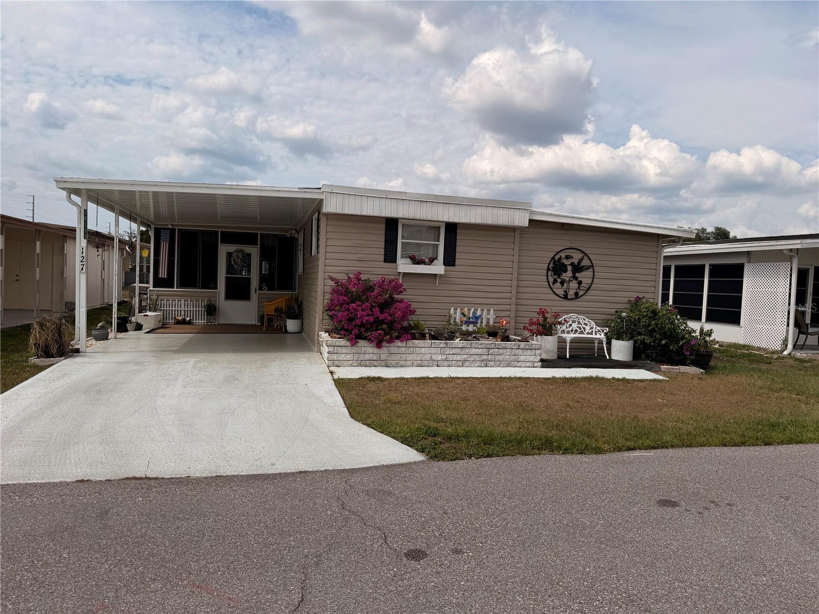 WELCOME HOME!  This two bedroom, two bathroom home is located in a 55+ community in Zephyrhills. Enter through the screened in porch with the enclosed laundry room at the back of the porch.  Upon entering this well kept partially furnished home., you will enter into the open floor plan of the large dining room, kitchen and living room. The home is also a split floor plan with a bedroom and bathroom on each end of the home. Walk out the back door onto the open patio with an enclosed workshop on one end. The home has a membrane and metal roof that was put on in 2025, new A/C installed in 2023 and new electrical panel. Sleepy Hollow Mobile Home Park has a clubhouse, shuffleboard courts, swimming pool with other events and is golf cart friendly. The home is located close to the hospital, medical facilities, Bealls Department Store, Ross, TJ Maxx, Publix and other retail stores. It is approximately 45 minutes to Tampa International Airport, Tampa General Hospital, Busch Gardens and other amusement parks. It is approximately one hour from Orlando with all the amusement parks and the Orlando International Airport. Dogs and cats allowed but, MUST be approved by the HOA.  Note: Dishwasher has never been used and is not connected to electric. Dishwasher must be hardwired. 

Call to schedule your private showing.
