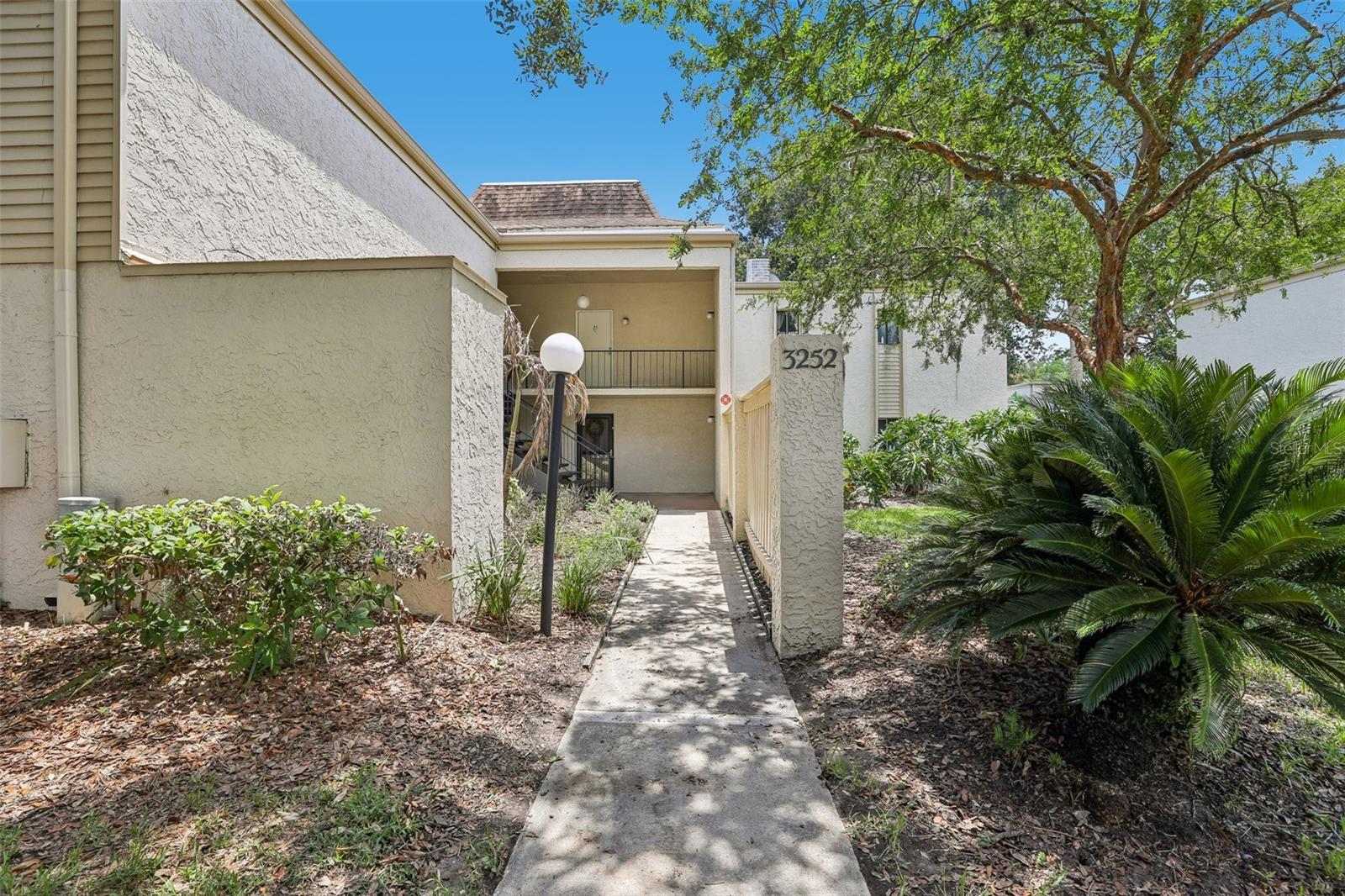 Virtually Staged. Welcome to the GATED Wimbledon community, where updated interiors, LOW MAINTENANCE LIVING, and an unbeatable East Orlando location come together in this inviting second-floor 2-bedroom, 2-bath condo! Recent updates include stylish NEW LUXURY VINYL PLANK FLOORING throughout the living area along with refreshed bathroom vanities, mirrors, and modern vanity lighting, creating a MOVE-IN READY space you will love coming home to. The interior delivers a light-filled floor plan for comfortable everyday living with an OPEN CONCEPT living and dining area that flows through sliding glass doors to a spacious SCREENED BALCONY overlooking a peaceful grassy courtyard and mature green space – the ideal spot to enjoy your morning coffee! The kitchen offers easy access to the main living spaces, while the FULL-SIZE LAUNDRY is conveniently located inside the unit. The spacious PRIMARY SUITE features a dedicated en-suite bath and a WALK-IN CLOSET, providing plenty of storage, while the second bedroom and full guest bath offer flexibility for guests, roommates, or a home office. Residents of Wimbledon enjoy a variety of fantastic AMENITIES including a COMMUNITY POOL, tennis courts, clubhouse, ASSIGNED PARKING, and LOW HOA fees, making this an excellent opportunity for both homeowners and investors. The community is known for its strong rental demand thanks to its proximity to Orlando International Airport, Lake Nona's Medical City, Downtown Orlando, and major employers. Perfectly positioned across from Ventura Country Club and just minutes from golf, shopping, dining, and entertainment, this home also offers quick access to SR 528, SR 408 and is less than an hour from Cocoa Beach. Whether you are in the market for your first home, a low-maintenance primary residence, or a smart investment property, this updated Wimbledon condo delivers exceptional value in one of East Orlando's most convenient locations. Call today!