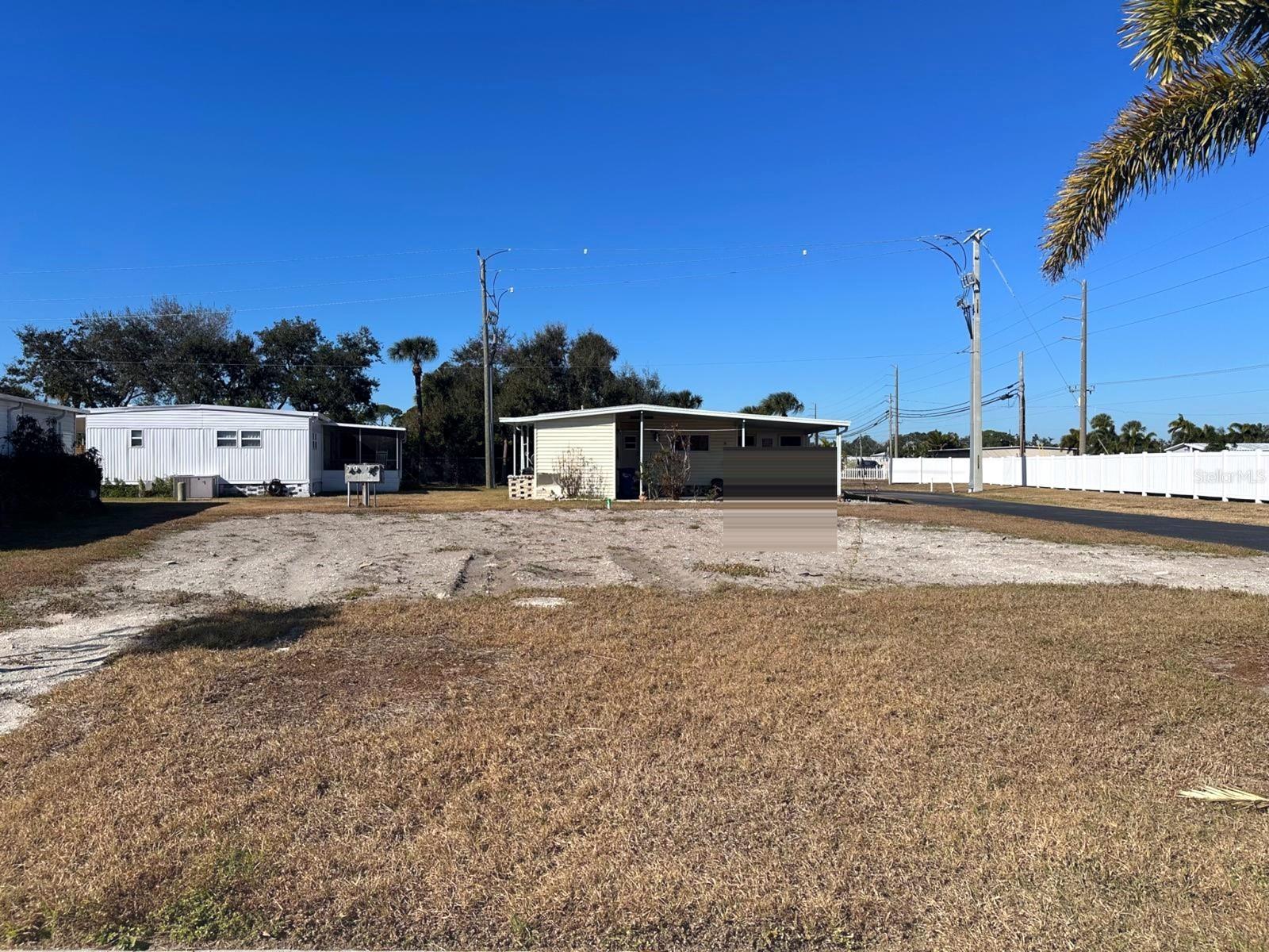 55+ co-op share in Chateau Village, Bradenton. Vacant corner lot for a new single or double-wide home. No lot rent. Flood Zone X.
Build your Florida getaway on this vacant corner lot in Chateau Village, a resident-owned 55+ cooperative community in Bradenton. This co-op share includes the right to place a new manufactured home on the site, with both single-wide and double-wide homes permitted. The lot previously accommodated a double-wide home and is ready for a new installation. There is no lot rent, making this an affordable opportunity within an established resident-owned community.

Water and electricity are available nearby for future connection. After purchase, plans for the new home are submitted to the association for approval in accordance with community guidelines. Homes are required to include a carport and storage shed. Whether you choose a single-wide or double-wide design, this lot offers the flexibility to create a home that fits your needs.

One of the strongest advantages of Chateau Village is the value included in the $250 monthly fee. Residents enjoy water, sewer, trash service, cable television, internet service, lawn care, community pool access, shuffleboard courts, clubhouse amenities, an on-site manager, and convenient back-gate access. These services and amenities are included through the resident-owned cooperative community.

Conveniently located near shopping, dining, banks, healthcare services, Sarasota-Bradenton International Airport, and Florida's Gulf Coast beaches, Chateau Village offers easy access to many of the area's most popular destinations. Whether you are planning a seasonal retreat or year-round Florida living, this vacant lot provides the opportunity to place a new manufactured home in a well-established cooperative community.
