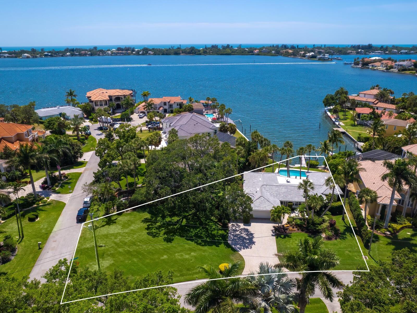 Price Improvement – Now $2,750,000!
Welcome to waterfront living at its finest in the heart of coveted Southpointe Shores.  This spacious residence offers direct Intracoastal Waterway access and breathtaking sweeping views of picturesque Siesta Key.  Situated on a rare half-acre corner lot (one of the largest in the neighborhood), the home remained high and dry during past storms.   The home sits in the X flood zone, giving you true peace of mind.
Recent investments make this home truly move-in ready:
•  New tile roof (2023)
•  New hurricane-impact windows & doors (2024)
•  Brand-new dock & 10,000 lb boat lift (2025) accommodating up to a 30’ boat
•  Updated LG & KitchenAid appliances
•  Pentair variable-speed pool pump, new Rain Bird irrigation, and fresh sod (2024)
Enjoy a luxurious primary suite, 4 bedrooms total, 3 baths, a sparkling pool, and a 3-car garage.  The private neighborhood park with boat ramp and day dock is just steps away, and voluntary HOA fees are a low $295 per year.
Detailed list of all improvements available in the MLS attachments. Architectural plans for second-story addition (including living area, full bath, closet, screened lanai, and open patio) are also included—perfect for buyers wanting even more space.
Don’t miss this exceptional opportunity for true Florida waterfront living. Homes like this in Southpointe Shores rarely become available. Schedule your private showing today!