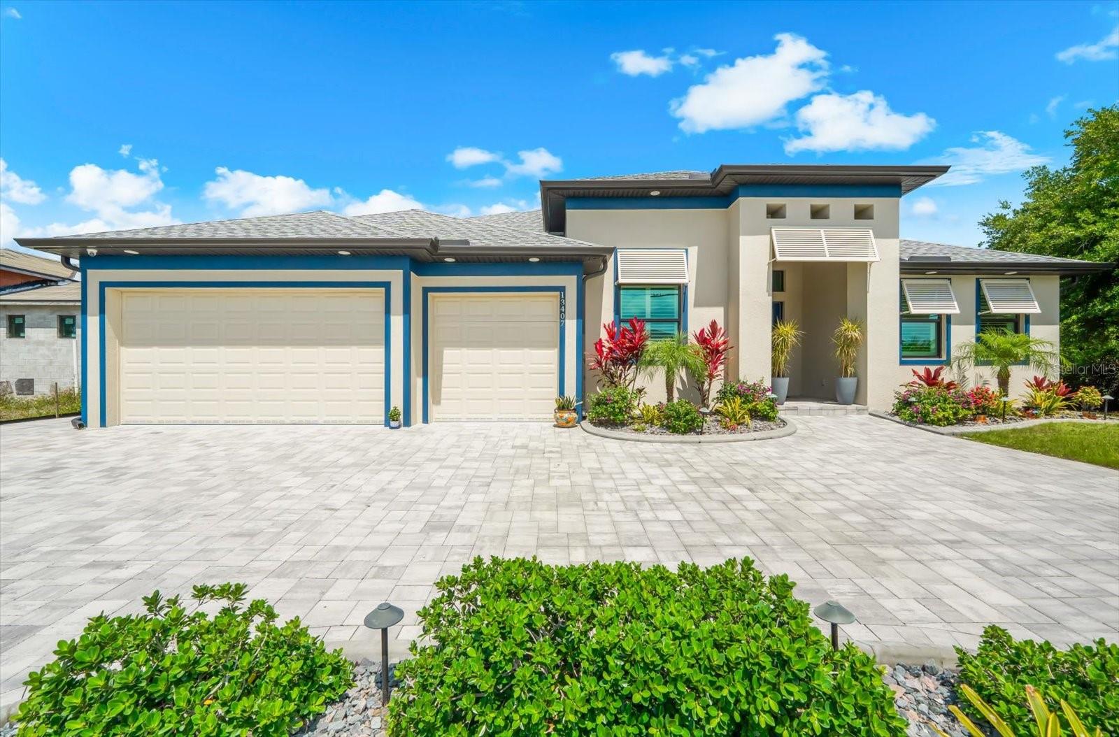 WELCOME TO YOUR WATERFRONT SHOWSTOPPER—STUNNING 3 BEDROOM, 3 BATH, plus DEN, GULF ACCESS HOME where LUXURY meets LIFESTYLE and every detail is designed to IMPRESS. Perfectly situated on a coveted Gulf-access canal, this home delivers EXCEPTIONAL BOATING OPPORTUNITIES with electric and water available at the waterline. From the moment you arrive, the elegant horseshoe driveway and lush, professionally designed landscaping create a PRIVATE OASIS, enhanced by dramatic landscape lighting and a beautiful stone walkway that wraps the home. Step through the custom glass double-door entry and into a BRIGHT, OPEN FLOORPLAN with a desirable split design, offering both functionality and privacy. Inside, you’ll find wide-plank tile flooring throughout, decorative tray ceilings, and recessed lighting that create a clean, MODERN yet inviting feel. The living space is nothing short of spectacular, highlighted by dramatic zero-corner sliding glass doors that fully pocket, and seamlessly blend INDOOR/OUTDOOR living. Plantation shutters add timeless elegance, while hurricane impact windows and doors provide peace of mind. At the heart of the home is a CHEF-INSPIRED KITCHEN that truly delivers—featuring premium GE Profile appliances, a sleek induction cooktop, double ovens, a statement designer hood, and level 4 granite countertops throughout. The massive 4x10 island is PERFECT for gatherings, while custom soft-close cabinetry, under-cabinet lighting, and a walk-in pantry with custom shelving elevate both style and function. Entertain effortlessly with a stylish indoor wet bar complete with a wine fridge—because every great home deserves a GREAT HOSTING SPACE. The expansive primary suite is your PRIVATE RETREAT, thoughtfully designed for comfort and relaxation. Enjoy a separate and private office with double-panel barn doors, an oversized custom walk-in closet with a built-in floating counter, and a SPA-INSPIRED bathroom featuring a wraparound walk-in shower with multiple shower heads, floor-to-ceiling custom tile, and a private water closet. Even the everyday essentials feel elevated with a spacious laundry room—complete with built-in countertops, a large single basin sink, and GE washer and dryer—conveniently located adjoining the primary suite. Step outside and experience RESORT-STYLE LIVING at its finest. The panoramic screened lanai and extended entertaining space set the stage for unforgettable moments, featuring a heated saltwater pool and spa, LED lighting, and a tranquil waterfall feature. An integrated audio system, roll-down shades for sun protection, and a fully equipped outdoor summer kitchen make this space truly NEXT LEVEL. This home is PACKED WITH HIGH-END UPGRADES including a Bosch tankless water heater, propane service for stove and dryer, whole house generator, high-efficiency Daikin HVAC system with 12-year warranty, HVAC surge protection, open-cell insulation, and three-zone climate control for personalized comfort. The air-conditioned, epoxy-floored garage offers even more versatility with a separate den and dedicated mini-split system—ideal for a gym, office, or FLEX SPACE— insulated garage doors for added efficiency. A canal-fed irrigation system keeps the grounds lush with ease, while a comprehensive whole-home security and camera system provides ultimate peace of mind. This is not just a home—it’s a BOLD STATEMENT of thoughtful upgrades and waterfront luxury. If you’ve been waiting for something that truly STANDS OUT… THIS IS IT.