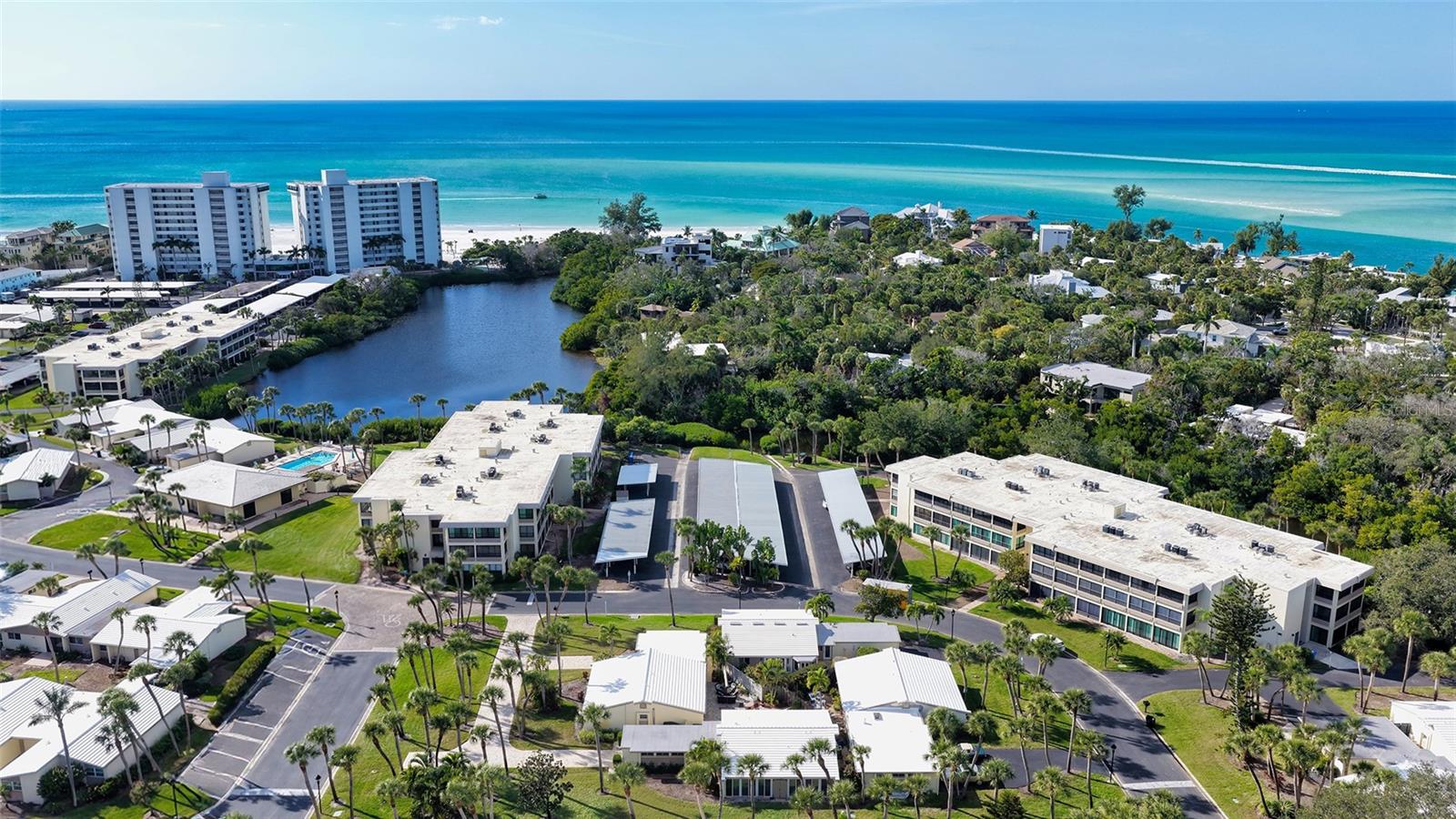 Welcome to your coastal retreat in the form of this secluded, 2 bed/2 bath freestanding villa with one car garage in the premiere GULF FRONT property of Whispering Sands.  OFFERED FURNISHED.  This surprisingly large, 1,462 square foot property has been UPDATED in 2025 with fresh paint, NEW crown molding & baseboards, NEW kitchen and updated baths. The exceptionally large living room allows for multiple seating groups, while a wall of floor to ceiling sliders – treated with beautiful shades - provides an abundance of natural light. Meal prep is easy in your bright NEW kitchen featuring white cabinetry, subway tile backsplash, granite counters, stainless Whirlpool appliances, recessed lighting, fandelier, & vinyl plank flooring. Three sets of new hurricane impact sliders open from the kitchen, dining room, and 2nd bedroom into your private fenced brick paver patio which offers valuable outdoor space for sunny relaxation or effortless entertaining.  Both newly carpeted bedrooms feature an extended living space to accommodate a small seating group, desk, or exercise equipment. The bathrooms have been refreshed with NEW granite countertops, cabinets, vanities & fixtures. NEW 2026 stacked W/D in garage. 2019 HVAC.  Recent enhancements include exterior pressure washing and villa painting in February 2026.  Newly updated brick paver driveway.  New landscaping is being planned by the HOA starting in 2026. Whispering Sands is a premiere 55+ Gulf front property ideally located next to the colorful boutiques and dining options of Siesta Key Village, and offers 800’ of PRIVATE beach, 2 heated pools, new beachside Tiki Hut, grills, shuffleboard, canoe/kayak storage, security, & onsite management. The clubhouse is scheduled to be remodeled in 2026 and when completed will include fitness rooms, catering kitchen, and an elegant and comfortable space for social gatherings.  Seller is willing to include 3 year new Kia SUV automobile with acceptable offer. Your coastal retreat awaits!