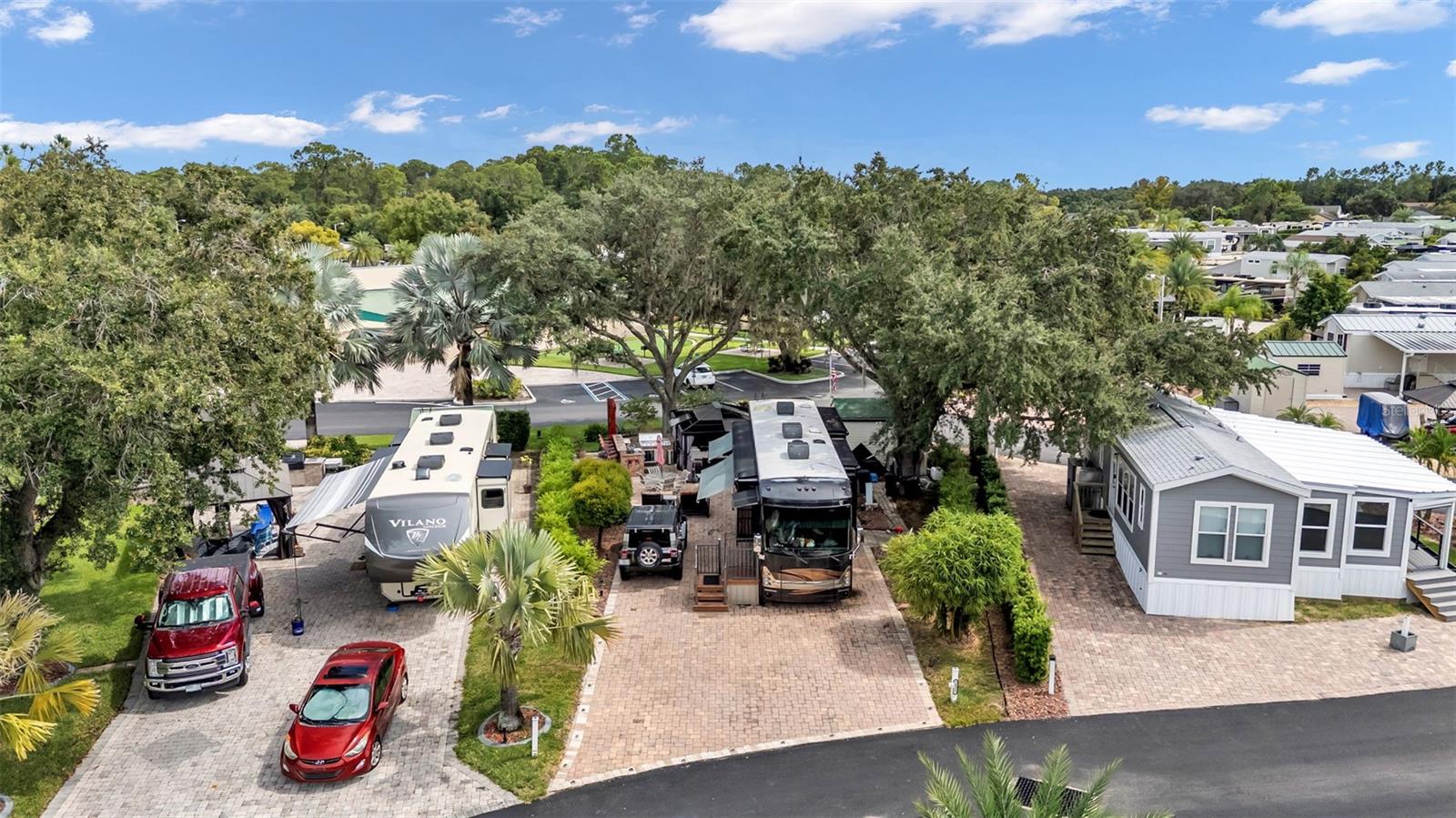 PRICE IMPROVEMENT! Beautiful lot in Elite Resorts at Citrus Valley! Park your RV on the extra wide and extra-long pie shaped paver pad and enjoy your own slice of Florida Living in this sought-after Clermont RV Resort. Lot 2 is a perimeter lot that conveniently backs directly up to the clubhouse and is located in a luxury portion of the resort ("The Oaks") which offers a lot of space and privacy. The 10x12 storage shed has laundry hook-ups and electric, plus the luxury outdoor grilling kitchen and mature landscaping create an outdoor-living oasis for you and guests! The lot has full hookups, room for parking, irrigation, landscape lighting, a grass area for pets and ample paver walkways. You have much more room than you'd expect on an RV lot, so there are tons of possibilities! This top quality resort is only 12 miles from Walt Disney World and offers many amenities including 2 resort bathhouses, laundry facilities, Bingo, a Veteran's Group, variety entertainment shows and social events. The lawn is cut regularly by the association and your HIGH SPEED INTERNET, cable, sewer, water and trash pick-up are all included in your quarterly Condo dues of $756. Low maintenance living, leaves you plenty of time to enjoy local attractions. You can call this beautiful property home in the Winter, or year round... Call today to set up your showing!