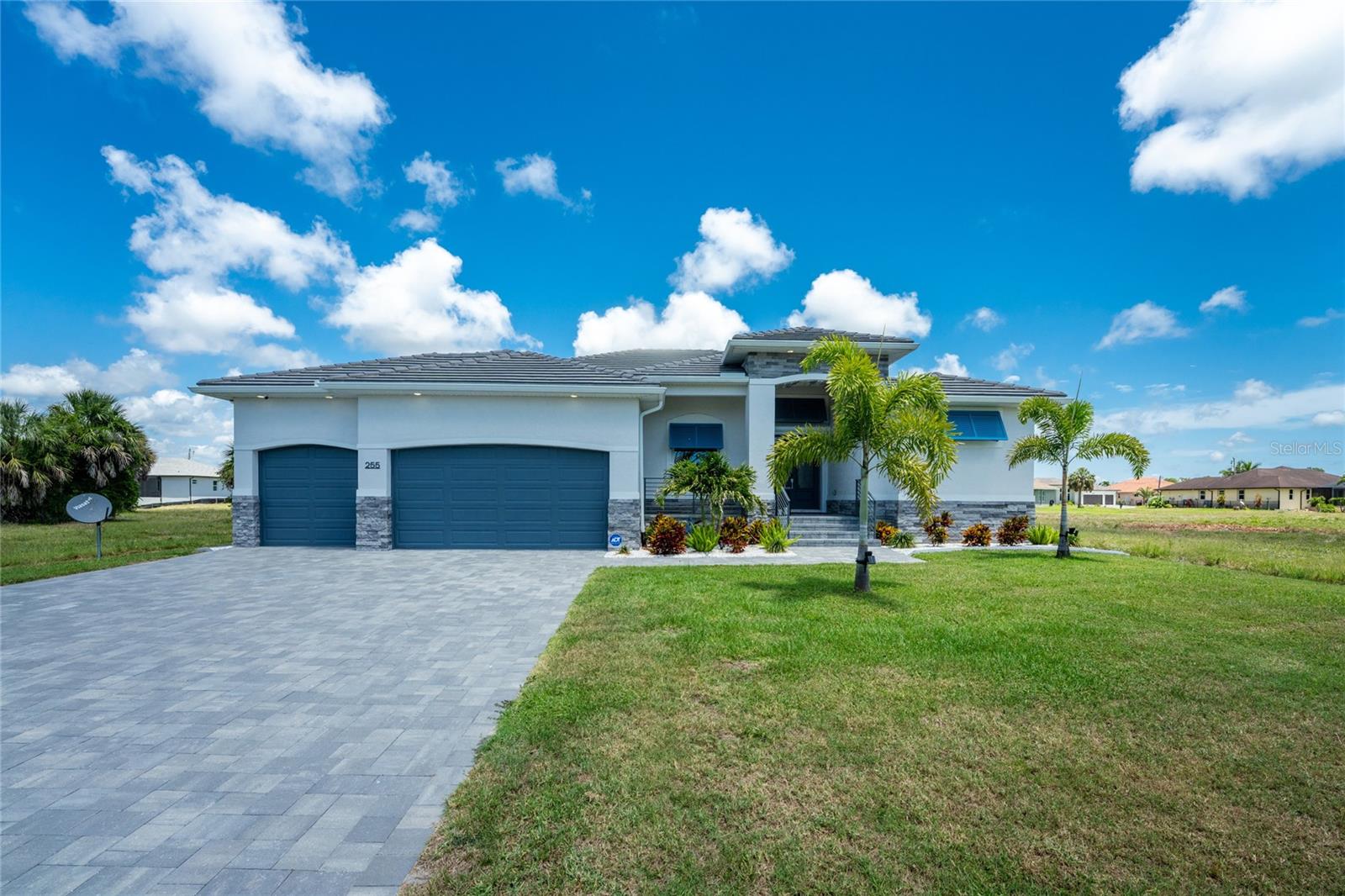 Built in 2025 and already elevated far beyond what you'll find in most new construction, this exceptional Rotonda West pool home features nearly $80,000 in premium upgrades and designer finishes, setting it apart from typical new construction. Offering 3 bedrooms plus an office/den that can serve as a fourth bedroom, 3 bathrooms, a 3-car garage, a private primary suite, and an additional ensuite guest bedroom, the home delivers a high level of finish and attention to detail. Gorgeous curb appeal with a paver driveway, stone accents, blue Bahama shutters, a tile roof, and a double etched glass door entry sets the stage for what’s inside. A welcoming foyer with a built-in custom bench and plank feature walls leads you into the open great room, where soaring 11 foot tray ceilings with crown molding and a fireplace wall with built-in cabinetry add character. A quadruple set of sliding glass doors opens wide, expanding your living space and making entertaining effortless. The kitchen features a large island, custom white shaker style cabinetry with several glass front accents, quartz countertops, tile backsplash, beverage refrigerator, and a walk-in pantry with custom shelving. The adjoining formal dining creates an inviting setting for both everyday meals and special occasions. The primary suite offers a spacious layout, tray ceiling with crown molding, pool access through sliding glass doors, and dual walk-in closets. The bathroom feels spa-like with double quartz topped vanities, a separate makeup vanity, custom finishes, and a Roman style walk-through shower complete with multiple showerheads and a built-in bench. The guest bedrooms are thoughtfully designed with privacy in mind. One bedroom features its own ensuite bathroom that also serves as a convenient pool bath, complete with a walk-in closet, walk-in shower, quartz topped vanity, and sliding glass doors. The guest bedrooms have easy access to a well-appointed guest bathroom with dual quartz topped vanity and walk-in shower. The laundry room continues with nice upgrades including built-in shelving, additional storage, and a built-in utility sink with quartz countertop. Outside, the lanai and saltwater heated pool area are where this home truly shines. A spacious, partially covered lanai features hurricane resistant sunshade blinds and ceiling fans. The well-fed irrigation system helps maintain the landscaping. Impact windows, shutters, and other storm-prepared features help protect the home when weather moves in. A monitored security system keeps you notified whether you are home full-time or away for extended periods. The three car garage features epoxy flooring, high ceilings, and additional storage. Home is in an AE flood zone with potentially assumable flood insurance, but buyers should verify coverage requirements with their preferred insurance agent. Rotonda West offers a lifestyle that is hard to beat, with multiple golf courses, miles of canals, lakes, pickleball, parks, and a peaceful setting. Just minutes away, Englewood brings you to some of the area’s best Gulf beaches, waterfront dining, local shops, and a laid back atmosphere so every day feels like you’re on vacation. Offered with the option to purchase furnishings makes this a truly move-in ready home. If you’ve been searching for a home that feels complete the moment you walk in, you’ll find it here at 250 Rotonda Blvd S in Rotonda West.