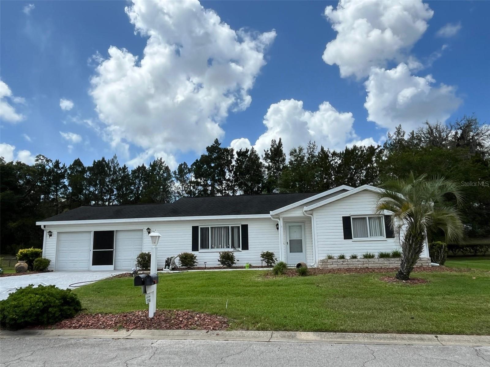 WHY DO SO MANY LOVE calling SPRUCE CREEK SOUTH their home? It is one of the area's most sought after gated golf communities with resort-style amenities and 24-hr guarded entry, This beautifully maintained 2-bedroom, 2-bath residence offers the perfect blend of comfort, privacy, and Florida living. Inside the PALM model layout features an oversized guest suite with a walk-in closet, abundant natural light enhanced by solar tubes, and inviting living spaces designed for both everyday comfort and entertaining. The expansive 288-square-foot Florida room creates the perfect setting for morning coffee, relaxing afternoons, or hosting family and friends year round. Step outside and enjoy your own private backyard retreat with mature professional landscaping and no rear neighbors for added peace and tranquility. The screened outdoor living area with paver flooring provides an ideal space to enjoy Florida’s beautiful weather, while the decorative painted driveway and extra-large garage add both curb appeal and functionality