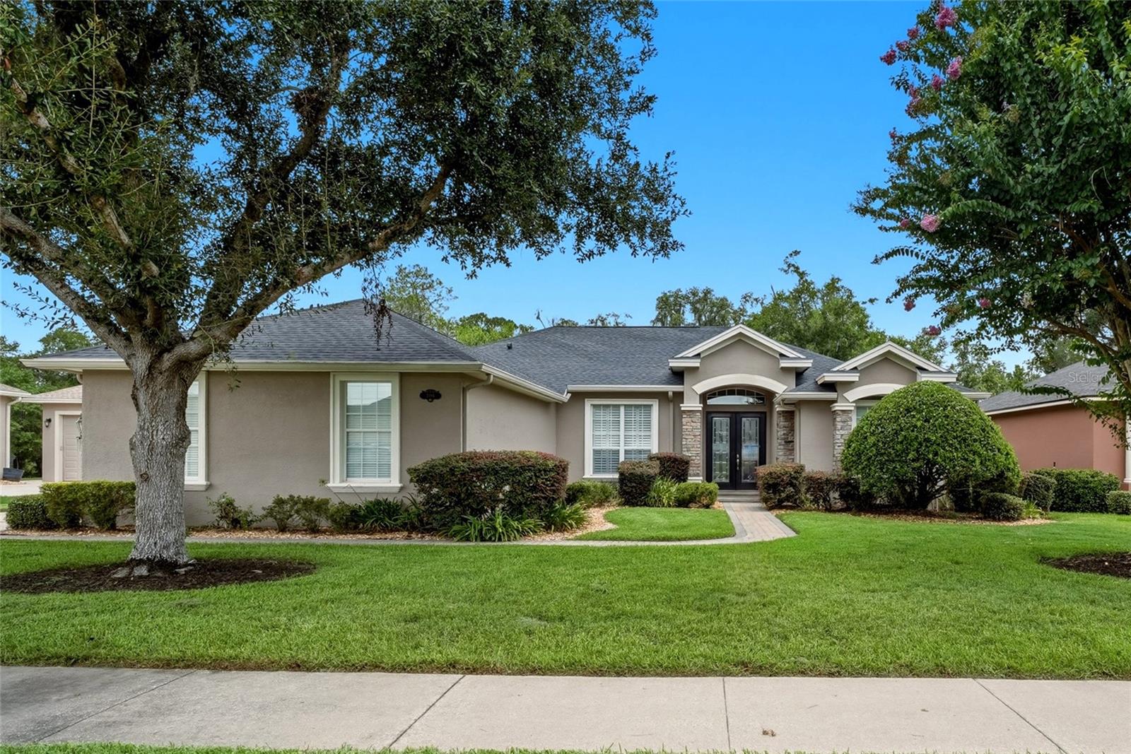 Welcome to Hawks Ridge, one of North Lakeland's most desirable gated communities, where mature tree lined streets, beautifully maintained homes, and a low HOA create an inviting place to call home. Situated on one of the largest homesites in the neighborhood at approximately 1.69 acres, this well maintained Hulbert Homes residence offers the space, privacy, and functional layout today's buyers are searching for. Conveniently located just minutes from I-4, shopping, dining, medical facilities, Lakeland Square Mall, and an easy commute to both Tampa and Orlando, this location blends peaceful living with everyday convenience.

Inside, you'll find 4 bedrooms, 2 bathrooms, a formal living room, formal dining room, and a spacious open concept kitchen featuring granite countertops, a large center island, abundant cabinetry, and a seamless flow into the family room, making it ideal for everyday living and entertaining. Rich hardwood floors and crown molding add warmth and timeless character throughout the main living areas.

The thoughtfully designed split bedroom floor plan provides privacy, with two secondary bedrooms separated from the primary suite. The spacious primary retreat offers private access to the screened lanai and features dual vanities, a jetted soaking tub, walk in shower, private water closet, and two generous walk in closets.

Step outside to enjoy the screened patio overlooking the expansive backyard, offering endless possibilities for outdoor living, gardening, recreation, or even adding a future pool.

Located within minutes to I4, commuting, traveling to theme parks, beaches and many other attractions make this location desirable for any lifestyle.  Locally you'll find easy access to shopping, dining, local parks and recreation, as well as schools, medical facilities and the growing Lakeland Linder Airport. 

Important updates include a brand new roof installed in July 2026, HVAC replaced in 2017, an indoor laundry room complete with washer, dryer, and utility sink, plus the original hot water heater conveniently located in the garage.

If you've been searching for a move in ready home with plenty of space, a desirable split floor plan, and the security of a gated community, this property offers an exceptional opportunity to enjoy the best of Central Florida living.