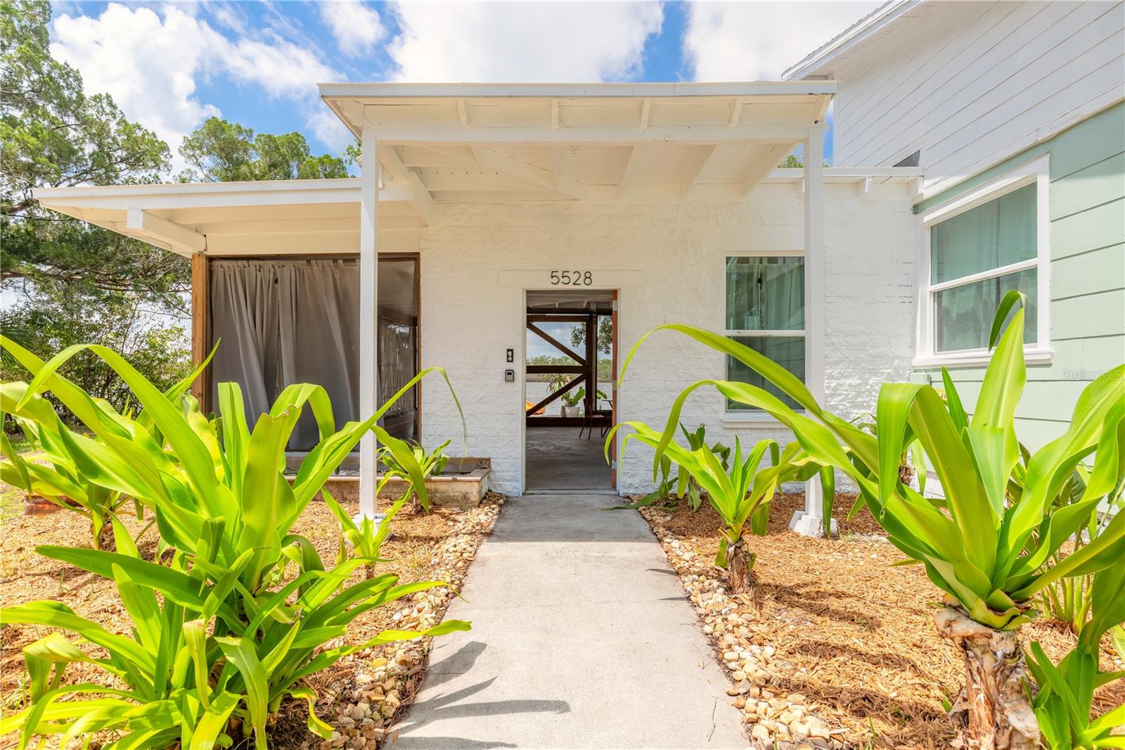 Direct waterfront 1Bd, 1Ba  coastal cottage home located in the desirable Harbor Oaks/Bay Shore area of Port Orange. This home offers 1,082 sq ft of living space on an oversized lot just minutes to the Intracoastal Waterway, parks, boat ramps, dining, and the beach.  The eat-in kitchen has stainless appliances, butcher block counter, and a gooseneck faucet. The large covered patio looks out over the lake/bay. There are two storage lockers located on the back patio. Conveniently located near schools, shopping, with easy access to Daytona Beach and New Smyrna Beach. This home could be a primary residence, vacation getaway, or investment opportunity.NO HOA!