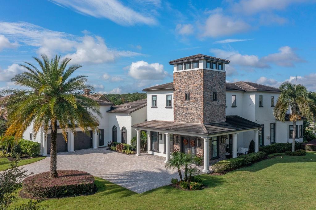 Redefine luxury living. Welcome home to an exceptional lifestyle with an estate that offers impeccable design and unparalleled sophistication in one of Central Florida's most desirable guard-gated communities, Keene's Pointe. This masterfully designed residence, which was fully reimagined and painstakingly renovated over 2 years, blends modern luxury with timeless elegance. No expense was spared and every corner was touched....this is what a real renovation looks like. Perfectly positioned on an expansive .85-acre corner homesite overlooking a tranquil pond, this 7,600 square foot residence welcomes you with a 32 foot tall open entry, taking full advantage of the year-round Florida sunshine. Just off the entry, you will find a private office featuring a coffered ceiling, designer lighting and glass pocket doors. The home offers 5 spacious ensuite bedrooms, including a lavish first floor primary suite, featuring a spa-inspired bath and impressive dressing room with extensive custom storage. In the second-story wing of the home, you will find three secondary ensuite bedrooms, each with beautifully updated baths plus a loft. A private guest suite, set on the second story of it own wing was expertly finished in 2022. Your guests will enjoy a large bedroom, kitchenette, seating area, private bath, large closet and a private entrance, making it the ideal space for extended family or visitors. The third wing of the home features an expansive theater room, with stadium seating, new wet bar and full bath. Entertain effortlessly with the open floor plan, combining living, dining and a seamless transition from inside to your private resort oasis, featuring saltwater pool, spa, outdoor fireplace, covered al fresco dining area with remote controlled screens, brand new open cabana with summer kitchen and bar, and ample green space. Inside, your chef's kitchen awaits, with a waterfall edge island, Thermador appliances, custom cabinetry and butler's pantry, with refrigerated drawers, ice maker and storage. Additional highlights include a 5 car garage, tankless hot water heaters, lighting automation, custom storage areas and dedicated irrigation well. Every detail of this home was carefully curated with timeless elegance, modern functionality and unmatched quality. Coupled with the effortless Florida lifestyle and located just minutes from Orlando's world class attractions and golf, this exceptional home is turn-key ready and truly special. Make your private appointment to see it today.
