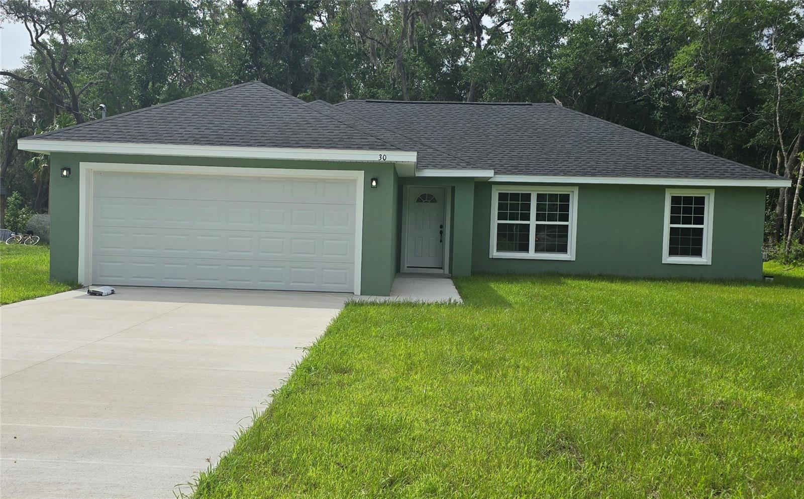 BUILT AND READY TO MOVE IN! Come see this wonderfully styled, 3 bedroom, 2 bath, 2 car garage on a .24 AC LOT in the quickly growing area. This home features a split plan, high ceilings & QUARTZ STONE counters in the KITCHEN, BATHROOMS & WINDOW LEDGES! When you step in side, you will notice the open design with tall ceilings and a split floor plan. The primary bedroom features an oversized closet & en suite bathroom with A FULLY TILED, EZ ENTRY SHOWER & linen closet. The kitchen, has whisper quiet drawers & UPGRADED cabinets with stylish knobs. Gorgeous sink with a beautiful open view. DELUXE SMART APPLIANCE PACKAGE INCLUDES Stainless steel Fridge, Dishwasher, Stove & Microwave comes with the home. A beautifully patterned Quartz counter island comes with room for chairs. Nearby, you have access to the laundry room & garage via a handy pocket door. Across the house, the secondary rooms share the bathroom and will have good space for a full size bedroom set, office, or a game room. The choices are endless! Ample closet space has been supplied as well for all of their storage needs. The .24 acre lot gives you plenty of room for all of your toys! NOT IN AN HOA so you are free to build a fence, add a pool, do what you want, how you want! On a well and septic system so NO UTILITY BILLS is also a great plus! If you install back up power in preparation for any possible outage, you will still have use of water and sewer as long as you have electric! Close enough to give you access to Belleview, Summerfield, The Villages, The Interstate and beyond. Less than 12 min to Wal-Mart, Publix, Aldi & Save a Lot, The post office, 3 auto parts stores & car washes as well as many food & medical offices nearby for ease. A short drive to our famous Lake Weir, where you can boat, kayak, jet ski, or enjoy a meal on the lake over looking the sunset. USDA, First Time Homebuyer & Veteran friendly!