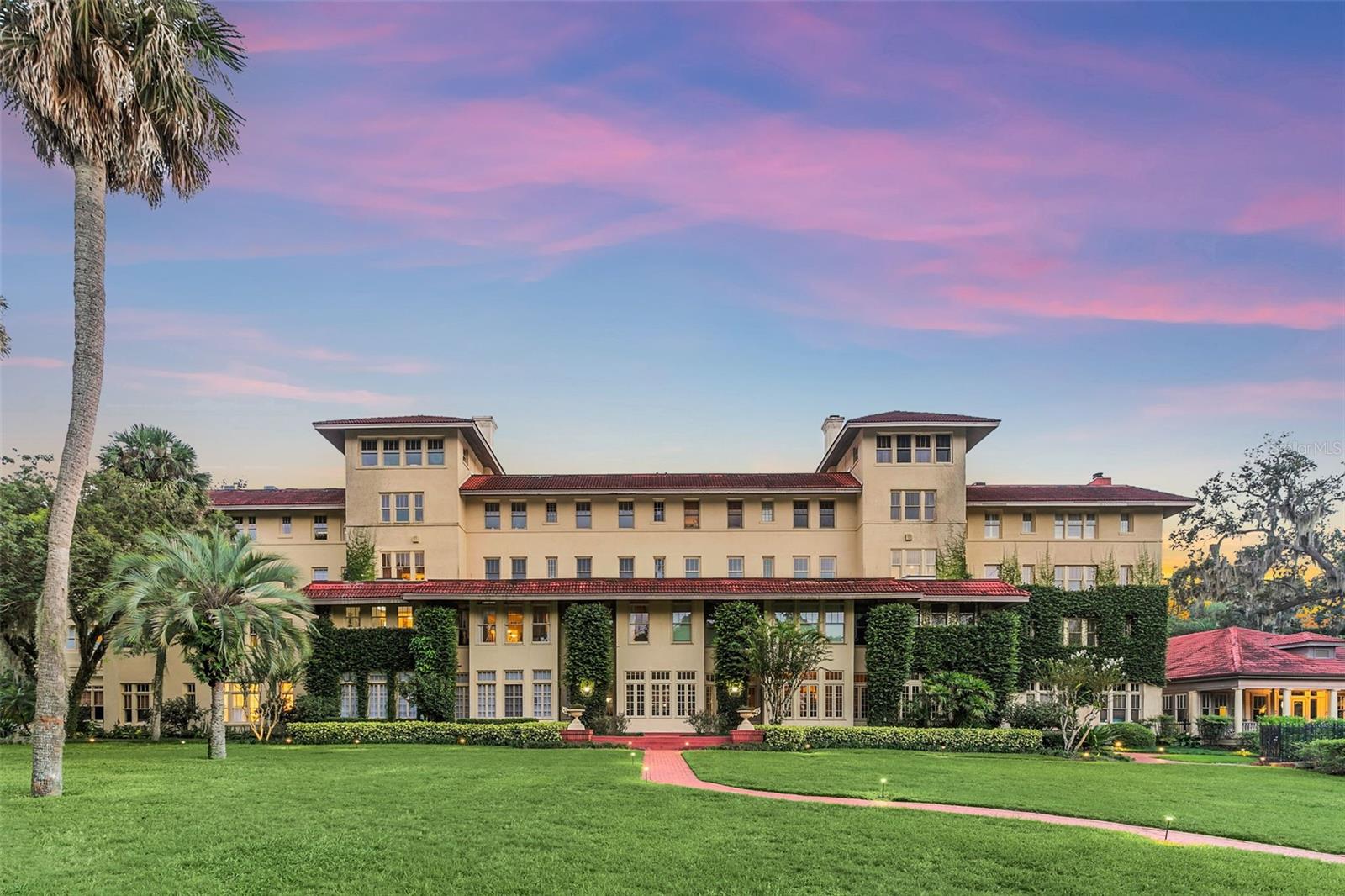 Welcome to the epitome of luxury living at The Alabama in beautiful Winter Park.  Nestled in one of Central Florida’s most sought-after neighborhoods, this exquisite condo offers a rare opportunity to experience the best of urban convenience and tranquil suburban charm.  Residents of the Alabama enjoy access to a range of amenities, including a sparkling pool, fitness center and a clubhouse for social gatherings. An intimate foyer welcomes you into this 2-bedroom, 2-bath unit with 993 square feet of space, gorgeous 7.5” plank White Oak floors and 11’ high ceilings throughout.  The well-appointed kitchen featuring Viking & Fisher/Paykel appliances, marble counter tops and ample cabinet space, opens to a great room with lake views.  Wake up to the soft Florida sun streaming through large windows of the Primary bedroom retreat which also showcases lake views, custom closet built-ins and a marble bath.  Guest suite currently furnished as a flex space opens up to a private 400 sq. ft. terrace with gate (only 5 private patios in entire complex).  Extra Details: Roof 2018, boat slip available (first come first serve), climate controlled storage closet, bike/scooter storage, 1 deeded covered parking space, plenty of guest parking, on site manager, property is gated and secured on over 5 acres on Chain of Lakes.  No rentals permitted, small pets most welcome.
Wether you step outside to your private terrace to unwind and enjoy a cup of coffee in the morning or enjoy the views of the well-manicured grounds/lush landscaping or watch sunset on Lake Maitland…your investment in a beloved piece of Winter Park's history is sure to enhance your lifestyle!  
Don’s miss the chance to make this luxurious condo your new home.