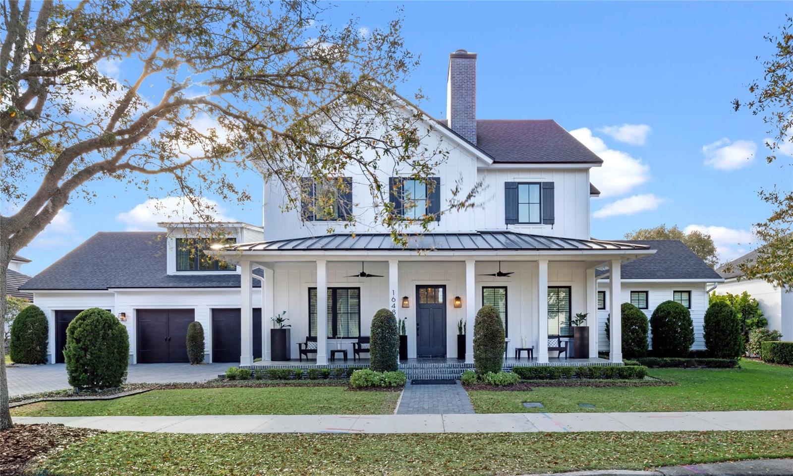 Presenting to you 1648 Harston Avenue! One of, if not The most unique and luxurious waterfront homes in Baldwin Park! Designed and Built by renowned Builder, Dave Cahill Homes as a Custom Coastal Modern Estate in a premiere location! Built in 2018, this immaculate estate boasts 4 large bedrooms with 4.5 bathrooms, 5,128 square feet of living space and rests on an over-sized .37 acre homesite. This versatile home features the owner's suite, second bedroom with full bathrooms attached, easily accessible pool bathroom and laundry room all on the first floor. 
     As you step inside, you'll be greeted by a wealth of desirable features. Beaming with natural light in every room, this spacious open floor plan seamlessly connects the living, dining, kitchen and outdoor living areas. The chef's gourmet kitchen and extra prep kitchen feature high-end stainless steel GE Monogram appliances, quartz countertops, and a large island, making it the perfect space for culinary enthusiasts to gather. 
     The family room is adorned with a fireplace and custom built-in shelving, adding both light and charm to each living space. For those who appreciate the finer things, the custom cabinetry, hardwood floors, elegant high-end fixtures and modern switchback stairs exude elegance. The owner's suite includes a massive walk-in closet and en-suite bathroom, ensuring a private retreat within the home. 
     Harston Avenue is an entertainer's dream! A fully upgraded sound system throughout the home will make hosting family and friends magical. The sliding glass doors open up to the enormous covered pool patio which features a cabana, outdoor kitchen, fire place and remote control screen enclosures. Relax and enjoy with guests outside or go for a swim in your 12 X 30 ft pool with sun deck and bubbler. Enjoy some of the most beautiful Florida sunsets and starry nights from the comfort of your back patio. 
     The attached 3-car garage provides convenient parking and even a space for your golf cart! Don't miss the opportunity to make this exceptional property your new home. Contact us today to schedule a private showing and experience the epitome of modern farmhouse living in Orlando!