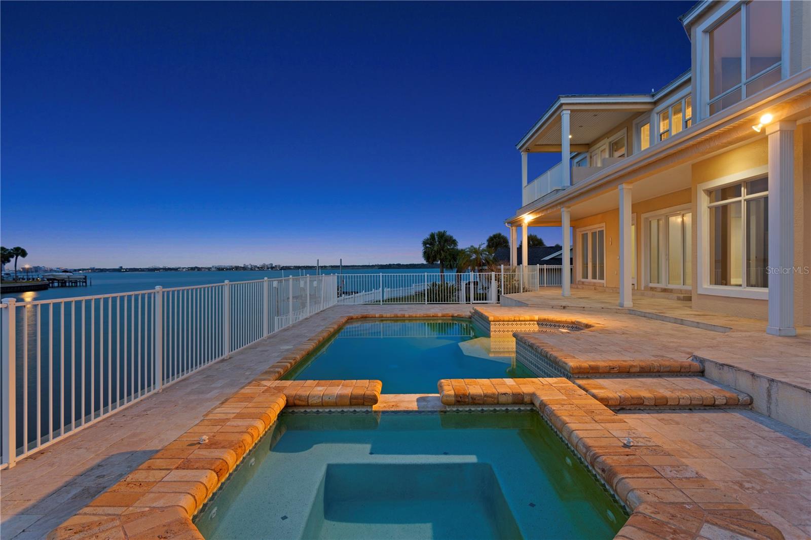 Under contract-accepting backup offers. One or more photo(s) has been virtually staged. Experience waterfront living with wide Intracoastal views, ideally positioned on a quiet cul-de-sac within Biltmore Isle in Belleair Beach. Featuring 105 feet of waterfront on a 12,000+ square foot lot, the property offers privacy, space, and direct water access.
Step inside to a dramatic two-story foyer with soaring ceilings and immediate water views, creating an impressive first impression. With over 5,000 square feet of living space, this block construction residence offers a traditional layout with a comfortable, functional flow.
Multiple living areas include a formal living room and a spacious main living area with a fireplace and built-in entertainment center. The kitchen is thoughtfully designed with granite countertops, stainless steel appliances, a center island, and a walk-in pantry, complemented by both casual and formal dining areas.
On the main level, two bedrooms share a Jack-and-Jill bathroom. An additional full bath with direct access to the outdoor living area is ideal for pool use. A separate room on this level offers flexibility for a home office, gym, or additional living space.
Upstairs, the owner’s suite is a true retreat, featuring water views, a sitting area, walk-in closet, and a covered balcony overlooking the Intracoastal. The en-suite bath includes dual vanities, a jetted tub, and a walk-in steam shower. Additional bedrooms include a private suite with its own en-suite bath and balcony, as well as another bedroom with a loft-style studio area, ideal for a game room, creative space, or lounge, also complemented by its own en-suite bath.
Outdoor living is designed for relaxation and entertaining, featuring a covered deck with multiple seating areas, a pool and spa with a sun deck, and a composite dock and seawall providing direct water access. Additional highlights include a circular paver driveway, garage workshop and storage space, and epoxy flooring.
The property offers exceptional outdoor space and the opportunity to enjoy both sunrise and sunset from different areas, with the Gulf beaches just a short walk away. The residence is elevated, adding an extra layer of peace of mind. A rare opportunity to own a waterfront home in Belleair Beach.