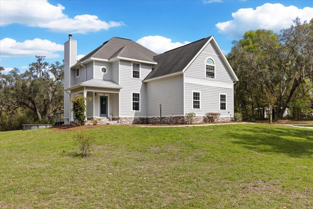 Motivated Seller * A stunning 4 bedroom/4 bathroom , 2 story home with loft AND Separate 1/1 bathroom mother in law suit on 2.43 gorgeous acres in Gilchrist County , only a short drive to Alachua County for easy commute! This property is a dream located in The Lake in the Woods Subdivision , offering a gorgeous country setting, Gilchrist county LOW property taxes yet an easy drive to Alachua County. This 2006 gorgeous home has been nearly completely remodeled over the last few years, featuring most brand new windows, new flooring, new carpet in the bedroom, all new appliances, new light fixtures, updated bathrooms, fresh paint on the inside and outside and refinished kitchen cabinetry. As you enter the property you are greeted with a complete perimeter fenced yard with a gorgeous new gate offering privacy. The drive leads you through the majestic oak trees to arrive at the home. A perfect 1/1 bathroom mother in law suite with a living room and kitchen, heating and cooling system as well as little fenced area for pets. The yard is spacious and plenty of room to enjoy the outdoors. A new back patio deck, a gorgeous pool and one shed will convey for storage. As you enter the home you see the beautiful foyer with a grand entrance of high gorgeous ceilings. A formal dining room (current use a bedroom) with custom barn doors. A large living room, wood burning fire place with a wonderful view into the back yard. Kitchen is nice and open with all udpated cabinetry and granite counter tops and a beautiful dinette area. Downstairs you also have the oversized master bedroom with an updated bathroom. As well as an extra bathroom perfect for guest. Garage is a two full car garage that houses the vehicles as well. Upstairs you have 3 full bedrooms, 2 bathrooms and an oversized loft (currently use as bedrooms) but would make a wonderful gaming room, entertaining space or office. Every aspect of the house feels like home. It's spacious, inviting and perfect for multi family and/or large families. The pool is perfect for Florida naturally warms all year temps and the location can't be beat. Call today to schedule YOUR tour!