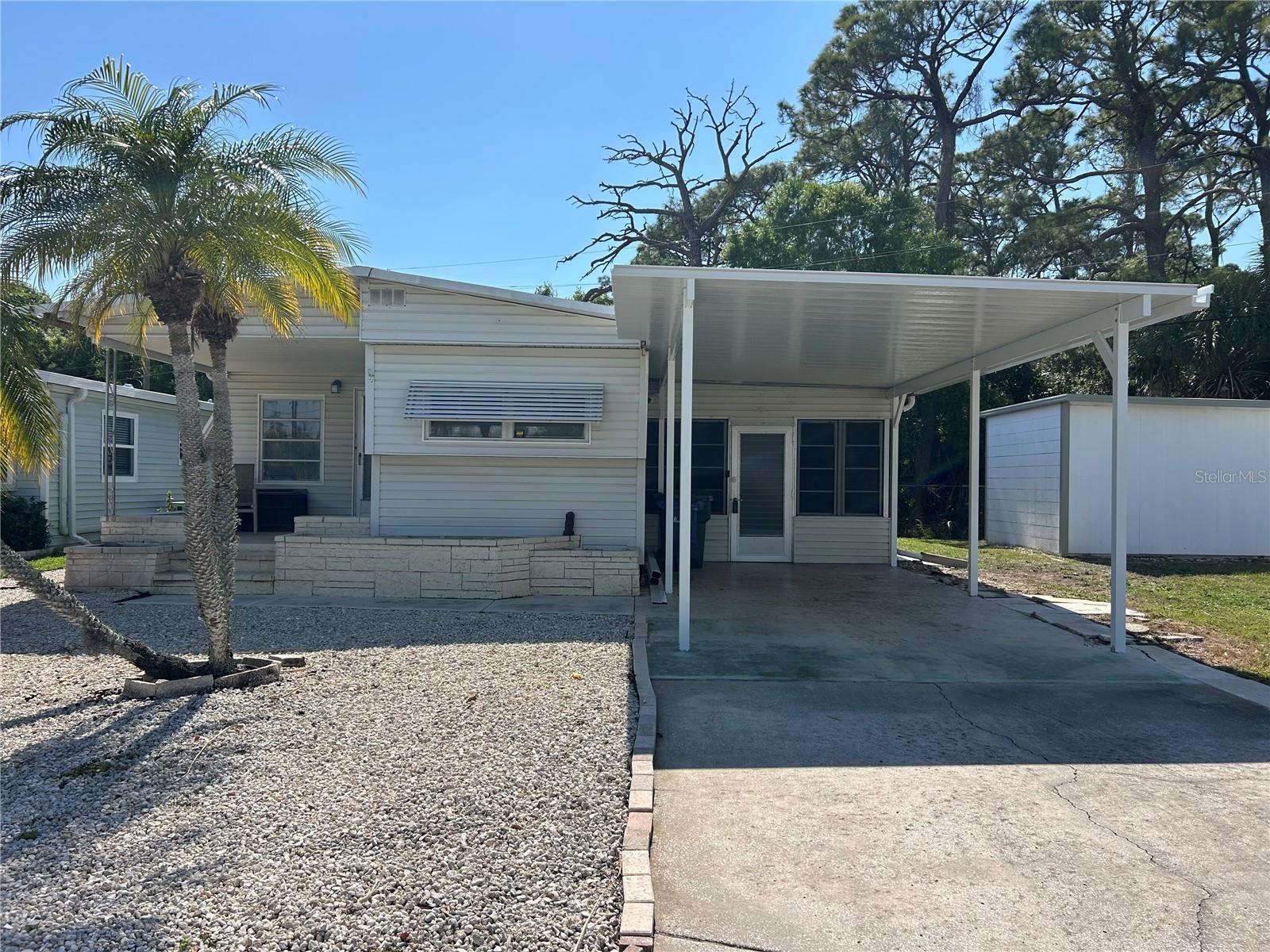 Attractive home - great location in Tri Par Estates. 2 bedroom, 1.5 bathrooms with 780 Sq.Ft. of living space. Brand new carport installed March of 2026. Purchase incudes; large Lanai/storage area & laundry room with a shower, Some new flooring since 2023, water heater 2023, HT/AC Mini Splits & some appliances 2017 This property is out of the flood zone code "X". Tri-Par Estates is a 55+ community in which you own your home and the land. A park fee of $1,648.00 a year is part of the property taxes paid once a year, includes Frontier internet, cable also trash. There is a large pool, hot tub, mini golf, laundry facilities, fitness room, clubhouse, and many activities to enjoy. Just minutes to the airport and many other like necessities nearby like hospitals, shopping, restaurants and more. Please do not disturb resident. Airplanes & jets do fly over Tri Par Estates. Tri Par is a state park & recreation development.