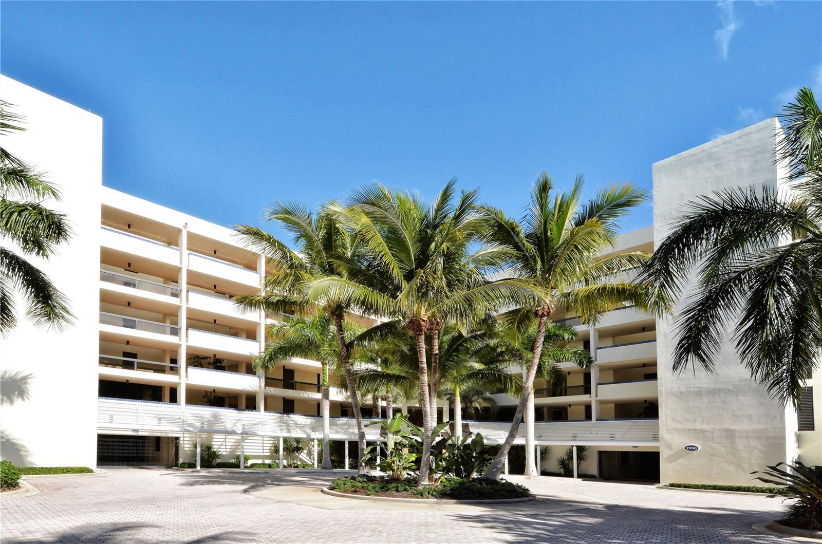 Welcome to your waterfront retreat in the highly sought-after Fairway Bay community, where relaxed coastal living meets thoughtful design and modern comfort. This beautifully renovated 2-bedroom, 2-bath condominium offers nearly 1,200 square feet of light-filled interior space, along with sweeping views of Sarasota Bay and the downtown skyline that create a stunning and ever-changing backdrop throughout the day.

Fully updated in 2020 and professionally curated by an interior designer, the residence showcases a refined yet inviting aesthetic. Inside, the open-concept layout is enhanced by warm, driftwood-inspired luxury vinyl plank flooring and an abundance of natural light. The living and dining areas flow effortlessly together, while expansive pocketing sliders open wide to a private balcony, creating a seamless indoor-outdoor experience ideal for both quiet mornings and evening entertaining. From this vantage point, you can take in tranquil water views, coastal breezes, and vibrant sunsets that define the Longboat Key lifestyle.

The galley-style kitchen is both stylish and functional, featuring quartz countertops, crisp Ivory soft-close cabinetry, New AC 2025, New Water Heater 2025, New Washer and Dryer 2025, stainless steel appliances installed in 2020, and a peninsula with seating that invites casual dining and conversation. The design balances clean lines with timeless finishes, making it equally suited for everyday living and hosting guests.

The spacious primary suite serves as a private sanctuary, offering generous proportions, beautiful bay views, and direct access to the peaceful ambiance of the home. The en-suite bath is thoughtfully appointed with dual vanities, elegant lighting, and a walk-in tiled shower, creating a spa-like atmosphere. The guest bedroom and accompanying bath are equally well-designed, providing comfort and privacy for visitors while maintaining the home’s cohesive style.

Additional features include plantation shutters on all windows and sliders, a private exterior entrance that enhances both convenience and privacy, a welcoming balcony seating area, and professionally landscaped surroundings that add to the property’s curb appeal. Important updates such as a new air conditioning system and water heater provide peace of mind, making this a truly move-in-ready opportunity.

Fairway Bay, located within the desirable Bay Isles community, offers a lifestyle rich in amenities and natural beauty. Residents enjoy gated entry with 24-hour guard service, beautifully maintained grounds, resort-style pools, a clubhouse, fitness center, and tennis courts. Scenic walking and biking paths wind along the bay, while a kayak and paddleboard launch provides easy access to the water for outdoor enthusiasts. Ownership also includes exclusive access to a private beach club on the Gulf of Mexico, offering the rare advantage of experiencing both serene bayfront living and pristine Gulf beaches.

Ideally situated near the renowned The St. Regis Longboat Key Resort, this residence is just moments from exceptional dining, shopping, and leisure experiences, further enhancing its appeal as both a full-time residence and seasonal escape.

This is more than just a condominium—it is an opportunity to embrace the relaxed elegance, natural beauty, and effortless lifestyle that make Longboat Key one of Florida’s most coveted coastal destinations.
