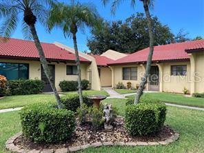 Welcome to this beautifully landscaped 55+ community. Move in ready south facing home with lots of bright sunlight and full privacy with no properties straight across from you looking in. Remodeled in 2024, kitchen has stainless steel appliances with low profile range, stainless hood and undermount kitchen sink, high-end quartz countertops with a ceramic backsplash. Led lighting throughout the home, luxury vinyl plank flooring and base moldings throughout the home. Spacious vaulted ceilings in the dining and living rooms. Large bedroom with lots of closet space. Large double glass patio sliders from living room to the air conditioned and window enclosed large lanai. Dedicated private covered parking spot also included. Community amenities include pool, ponds, fountain, tennis and pickleball courts, shuffleboard courts, a library, and a card room, ensuring there's always something to enjoy and all close to restaurants, beaches and amenities.