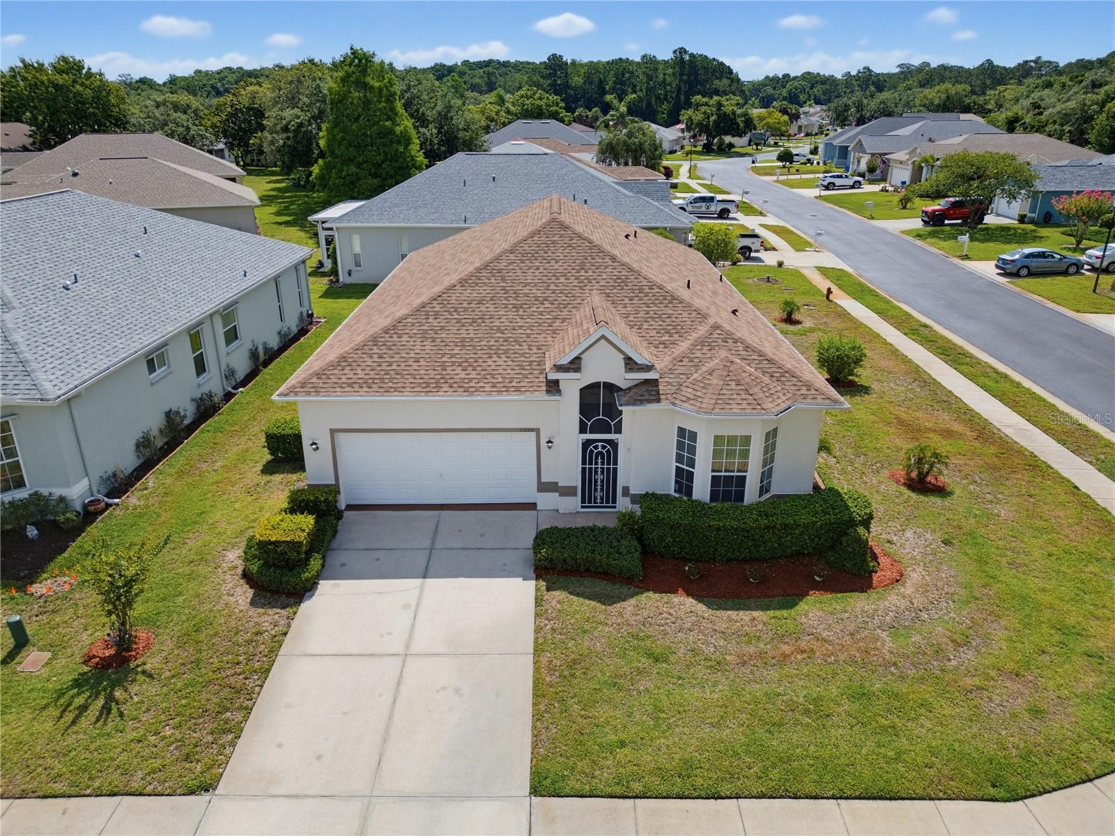 Welcome to the lifestyle you've earned.

Situated on a spacious corner lot in the highly desirable gated 55+ community of SummerTree, this beautifully maintained and move-in ready home offers the perfect combination of comfort, convenience, and an active Florida lifestyle. Thoughtfully refreshed and professionally staged to showcase its full potential, this home stands out among the many options available in today's market.

Inside, you'll find a bright and inviting floor plan designed for easy everyday living. The spacious living and dining areas flow seamlessly into the well-appointed kitchen featuring granite countertops, stainless steel appliances, ample storage, and a breakfast bar perfect for casual meals or entertaining guests. Natural light fills the home, creating a warm and welcoming atmosphere throughout.

The split-bedroom layout provides privacy for both owners and visitors. Two guest bedrooms and a full bath are located toward the front of the home, while the primary suite offers a peaceful retreat with a walk-in closet and private en-suite bath. A recently updated shower enclosure adds a fresh touch to the owner's bathroom. The Florida room provides additional living space and is the perfect spot to enjoy morning coffee, an afternoon book, or evening conversations with friends.

Additional improvements include a roof replacement in 2022, an epoxy-coated garage floor, refreshed interior finishes, and meticulous upkeep that make this home truly move-in ready.

But what truly sets this property apart is the lifestyle that comes with it.

SummerTree residents enjoy a vibrant, amenity-rich community where lawn care, exterior painting, pest control, cable TV, internet, trash service, and exterior maintenance are included, allowing you to spend less time working and more time enjoying life. Community amenities include a renovated clubhouse, fitness center, heated pool and spa, tennis courts, pickleball courts, shuffleboard, billiards, library, walking trails, social clubs, year-round activities, and a 9-hole golf course with driving range.

Whether you're looking to stay active, make new friends, travel more, or simply enjoy a maintenance-free lifestyle, SummerTree offers the opportunity to live each day like you're on vacation.

Come discover why so many residents are proud to call SummerTree home. Your next chapter starts here.