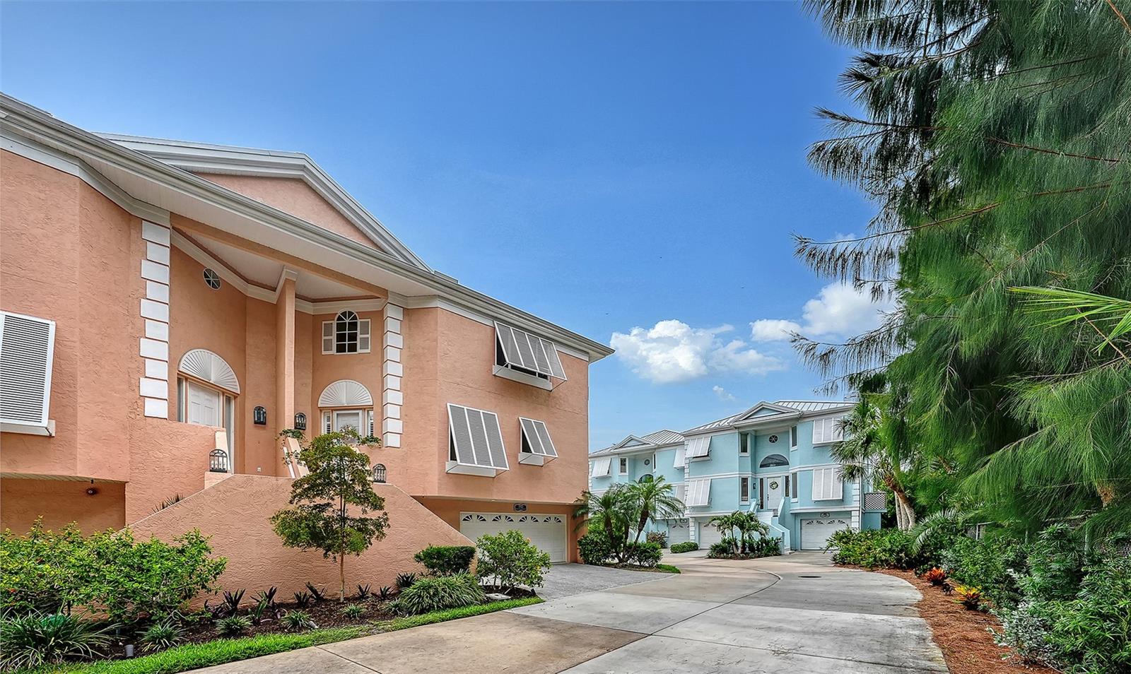 Siesta Key, exclusive gated community of only 18 homes with Marina, pool and tennis all within a private, lush, tropical paradise . Walking paths around the lagoon as well as the beautiful Marina make Hamilton Club a truly unique lifestyle. Inspired by the architcture of Bermuda with its close ties to 17th Century Great Britian is recognised by its striking pastel colored walls and "welcoming arms" staircases . Very close to the Village and Beach , yet equally convenient to Downtown . This sophisticated townhome has been completly renovated with fine finishes , wood and stone prevail with architectural beauty . Soaring ceilings bring in the most elegant lighting . The kitchen with its sweeping bar of magnificent granite  can accomodate a large party-open to the Great Room , it is both sleek and inviting  .Premium appliances include Miele, Bosch , GE and KitchenAid .Expansive counter space , built in shelving and a variety of pantries and drawers add to the incredible functionality. The Great Room with 20 foot ceilings opens to the screened balcony with a charming view of the lagoon and pool area . The primary bedroom is enhanced by the stunning view of treetops and is all the more cozy for having its own fireplace . Impact rated windows and a metal roof  combine to make this solid structure weather worthy . On the ground floor , in addition to the oversized two car gargage is a climate controlled bonus room which opens to the ground floor lanai . Boating , swimming , tennis and walking paths , within a private and peaceful environment close to everything -that is the Hamilton Club .