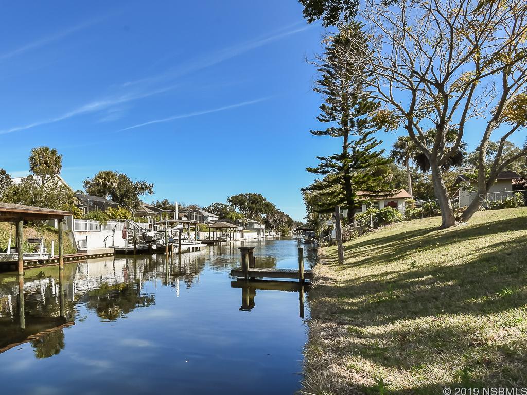 This waterfront ranch style home and property is truly a "fisherman's paradise". Located at the north end of the Canaveral National Seashore. You will have a wonderful time fishing, clamming, oystering, shrimping, crabbing, kayaking, island camping, hiking, bird watching, etc. Enjoy observing manatees, dolphins, sea birds and many other Florida animals. Our home has everything you need to enjoy the outdoors, as well as a pool to cool off during the Summer months. In the Winter, snuggle up near the wood burning fireplace. The canal leads to the intracoastal waterway. The neighborhood is on a quiet dead end street. Only takes 10 minutes to get to the Atlantic Ocean by boat and 15-20 by car. Take pleasure in the small town flavor of Edgewater with seafood restaurants, mom & pop diners and steakhouses. After a fun day on the ICW, enjoy holiday parades, festivals, and parks. Enjoy the wonderful town of New Smyrna Beach located on the Atlantic Ocean and full of restaurants, bars, festivals, art galleries, car shows, and a lively downtown area on the mainland side. Edgewater is located 30 minutes from Daytona Beach, 30 minutes from Cape Canaveral and about an hour from Disney World and the Orlando attractions. Never a dull moment in Central Florida. Ranch style home with an open great room (living, dining and kitchen), a master bedroom suite/in-law suite with private entrance and patio, second and third bedrooms, 2 full bathrooms, screened in pool, indoor laundry room, attached storage ("fishing") room, shed, solar heating for pool and large pool deck. Wood blinds or shutters on all windows. Tile in great room and bathrooms. Carpet in bedrooms. Between 2016-17, replaced roof, AC, water heater, installed hurricane proof windows on south and west sides of the house, solar heating replumbed and solar clips replaced. Very East to Show. Move in ready house! ;Water: City