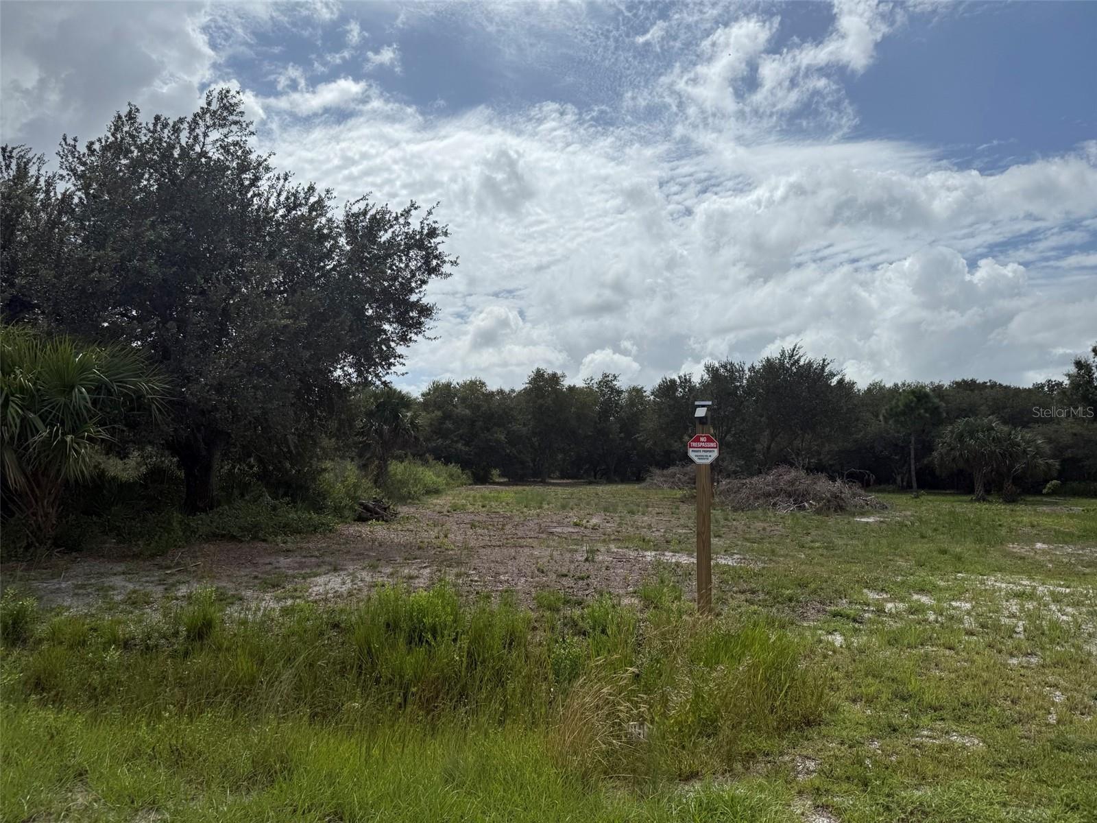 Financing Available! Build or bring your dream home and barn to this beautiful and private 1.25-acre lot in Okeechobee County. This property offers the perfect setting for those who enjoy the outdoors, whether it’s fishing, hunting, mudding, agriculture, or simply the peace and privacy of country living. Located near Kissimmee River Preserve State Park and the Kissimmee River, which flows into Lake Okeechobee, you’ll have access to some of the best fishing in Florida. The lot is cleared, surveyed, featuring a culvert already in place. Property corners are clearly marked in the front with 6x6 wood stunts (8 ft, with 4 ft set in the ground) for easy identification of boundaries. Don’t miss this opportunity to own your slice of paradise! Buyer to verify all property details including zoning, utilities, land use, and building requirements. All information deemed reliable but not guaranteed.