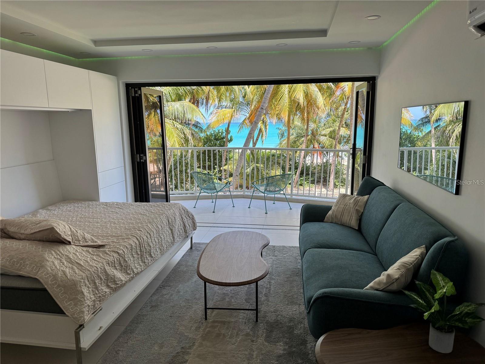 Located on the absolute perfect part of Isla Verde beach, where ample shade on the north coast’s best beach awaits you beneath plenty of beautiful palms, is this full gut remodeled luxury studio. The ideal beach second home, 7 minutes from SJU, walking distance to convenience marts, groceries, coffee and restaurants, you cannot ask for a better location. Wall-to-wall hurricane grade accordion sliders open to a large terrace right in front of the sea. Hi durability PVC cabinetry throughout has tons of storage. A queen murphy bed lets you wake up with the sun and sea in your eyes. Fully equipped with w/d, a/c, convection oven and cooktop/extractor. Condo pool is right outside your door. Call today!