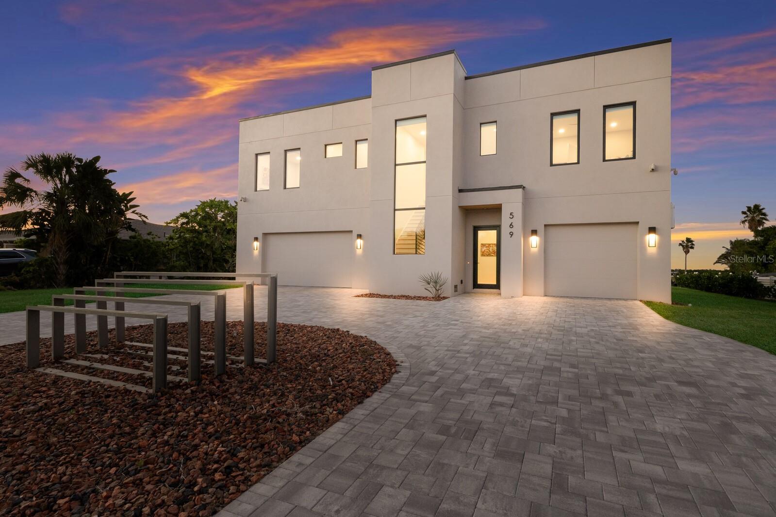 STUNNING New Construction WATERFRONT Home in LONGBOAT KEY ESTATES!!! Experience the pinnacle of coastal luxury in this new modern waterfront residence, perfectly positioned in one of Longboat Key’s most prestigious neighborhoods. Completed at the end of 2024, this architectural masterpiece offers direct Sarasota Bay access and a DEEDED BEACH ACCESS just steps away—the rare opportunity to enjoy both boating and beachside living in one extraordinary setting. Built to today’s highest standards, this all-block concrete home is designed for peace of mind with hurricane impact windows and doors, and engineered to withstand the toughest conditions while exuding timeless sophistication. Clean architectural lines, expansive glass, and a balanced façade define its striking contemporary profile, with an impressive entry that introduces the home’s elegant yet minimalist aesthetic. Inside, a spacious open concept living area seamlessly blends modern design with coastal comfort. The great room centers around a sleek gas fireplace framed by custom built-ins, while floor-to-ceiling sliding doors flood the space with natural light and open to the waterfront terrace. The gourmet kitchen is a showpiece in itself, featuring a massive quartz island with seating for five, custom dark cabinetry, glass subway tile backsplash, and top-tier Italian stainless-steel appliances, including double wall ovens and a gas cooktop. Designer lighting adds a bold splash of color, balancing style and warmth for effortless entertaining. Step outside to a covered deck that extends the main living area, complete with a full summer kitchen, wood-paneled ceiling, and multiple fans for year-round comfort. The third floor rooftop terrace delivers panoramic 360 degree views of the bay and beach—perfect for enjoying unforgettable Florida sunsets. The home offers three luxurious ensuite bedrooms, each with spa like bathrooms and designer finishes. The primary suite is a private sanctuary overlooking the water, featuring a large walk-in closet and a lavish bath with soaking tub, dual vanities, and an oversized walk-in shower. A private mother-in-law suite includes its own bedroom, bath, and full kitchen, providing ideal accommodations for guests or extended family. The backyard oasis is anchored by a sparkling lap pool surrounded by modern pavers and lush tropical landscaping. A brand-new seawall and dock provide deep water access to Sarasota Bay with no fixed bridges to the Gulf, making it a boater’s dream. The four car garage and in-home elevator add both convenience and functionality to this exceptional property. Located in the heart of Longboat Key, just steps from Bayfront Park and minutes from Saint Armands Circle and downtown Sarasota, this home delivers an unparalleled lifestyle. Enjoy world class dining, boutique shopping, championship golf, and some of the most beautiful beaches on Florida’s Gulf Coast—all at your doorstep. DO NOT WAIT ON THIS AMAZING OPPORTUNITY!