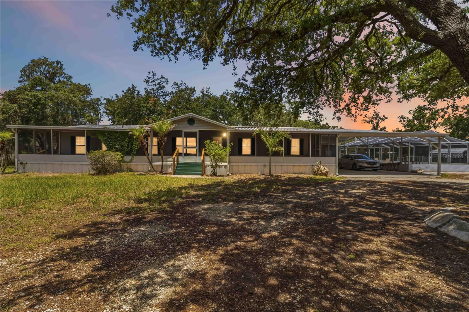 Virtually Staged. Welcome to this sprawling retreat where you can truly live on your own terms with absolutely NO HOA and NO CDD restrictions. Say goodbye to restrictive rules, nosey boards, and hidden monthly fees. Here, you have the total freedom to bring your toys, park your boat, and enjoy true property ownership. From the moment you arrive, the incredible curb appeal catches your eye, with the home beautifully nestled on a lush, expansive lot surrounded by mature shade trees and welcoming palms.

Start your peaceful Florida mornings on the massive, fully covered, and screened front porch that spans the entire length of the home, offering the perfect spot for outdoor dining, lounging, or just enjoying the breeze. Stepping inside, you are greeted by an expansive front sitting area featuring beautiful wood laminate flooring and an abundance of natural light. This versatile space flows effortlessly into a dedicated dining area, creating an open and inviting atmosphere that is absolutely ideal for hosting gatherings and entertaining guests.

The heart of the home features a cheerful, fully equipped kitchen complete with crisp white cabinetry, a convenient breakfast bar island setup, warm yellow accent walls, and a full suite of white appliances—including a dishwasher, range, and a spacious side-by-side refrigerator. Tucked away just beyond the kitchen is a separate, cozy living room highlighted by a stunning wood-mantel fireplace with built-in side cabinets, making it the ultimate destination for relaxing movie nights or winding down by the fire.

When it is time to unwind, the exceptionally spacious primary bedroom offers a peaceful sanctuary with its soothing blue walls, plush carpeting, and more than enough room for a king-sized bed and a private sitting area. Two additional bedroom offer the perfect layout to accommodate overnight guests. Step out back into your own backyard paradise, where a massive, fully screened-in pool cage encloses a sparkling blue pool and a generous concrete deck, providing the ultimate private space for sunbathing, swimming, and weekend BBQs.

This highly functional layout is designed for modern living, boasting an indoor laundry room, ample closet storage, a screened back patio, and an oversized 28'9" x 47'4" carport to easily accommodate multiple vehicles, a boat, or a workshop setup. Properties with this much space, a private pool, and zero restrictions are incredibly rare in Riverview.