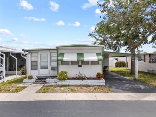 VOTED #1 MOBILE HOME PARK IN LARGO FOR 2025!  BEAUTIFUL OLYMPIC SIZE HEATED POOL! PARK IS LOCATED ON LAKE SEMINOLE. Cute property in Lake Seminole Resort with big opportunities.   Large sunroom which is used as a second bedroom with an armoire for your all your beach clothing.  Also in this room for your convenience is a washer & dryer and a desk & chair if you want to use as an office.  So much opportunity for this space to make it your own.  Primary bedroom is a great size as well, with dual closets, built in dresser and entrance to the bath which houses double sinks and a nice, tiled walk-in shower.   Propane stove for cooking, in wall AC as backup for central AC if needed, well water for lawns & plants plus a rubber roof.  Everything works as it should. Lake Seminole Resort is a 55+ resident-owned community and is highly sought after.  $55,000 land share value included in the asking price!  There are so many community amenities to enjoy, an Olympic sized heated pool, heated spa, lakefront access, a fishing pier, boat docks, boat storage, shuffleboard courts, a clubhouse, library, outdoor pavilion, outdoor showers, restrooms, and a community laundry room.  Located just minutes away (approx., 5 miles) from the Gulf waters with its white sugar sand beaches, great shopping, entertainment options, Tampa and St. Pete airports are approx. 30 minutes away!  It's all about that OLYMPIC SIZED HEATED POOL!!