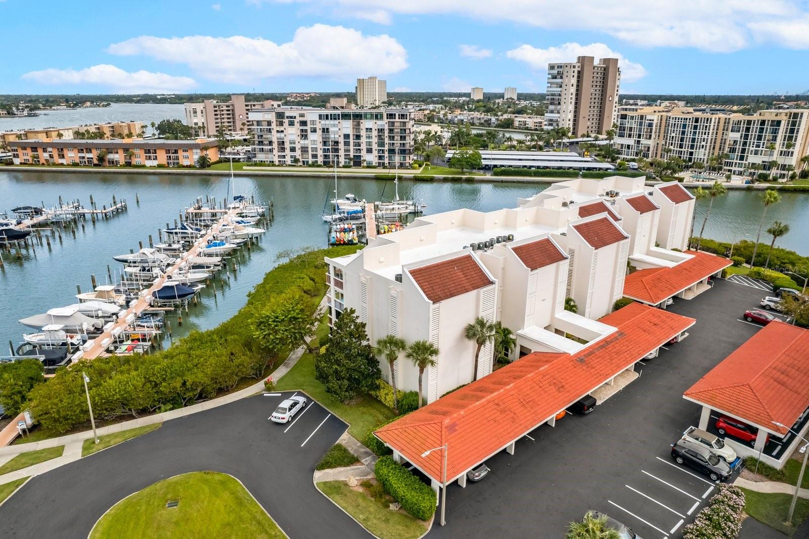 Welcome to The Harbourside community and enjoy coastal living at its finest in this 2 Bedroom/2 Bath Condo.  Harbourside is located in the heart of South Pasadena. Enjoy the open floor plan and the extra large balcony as you watch the sunrise and the view of the Marina and Boca Ciega Bay.  Savannah bldg is just steps from the Active Clubhouse,  Pool and Marina. (There is no Boat Slip with this unit)  Savannah buildings have passed the Milestone Inspection and are in compliance with the SIRS. For added convenience, the condo includes an inside laundry closet with washer and dryer, plus a covered, assigned carport space #30. Condo had modifications to accommodate wheelchair.  Harbourside is a Luxurious Waterfront condominium community,  immaculately maintained with 24/7 Guard Gate. Amenities include 6 swimming pools, 5 tennis courts with Pickle ball courts, 2 fitness centers, Men and Women's Gyms, Jacuzzi, saunas, Wood working shop, shuffleboard, outdoor grilling, 3 car wash station with vacuum & air, Car Charging stations, Marina with 3 docks and 87 deeded slips. There is no deeded slip to this unit but there are slips available to rent or purchase from other owners. There is an Active Clubhouse with a full social agenda and a 1.5-mile walking trail around the island to exercise or walk your pet. Savannah allows owners one pet under 20 pounds. Harbourside is located just minutes from the Popular Pristine West Coast Fl beaches and Minutes from I 275 and Downtown St Petersburg where you can enjoy the St Pete Pier, Museums, Art Galleries, Dining and all the History of the City of St Petersburg. Welcome to Harbourside and enjoy Resort style living at its best.