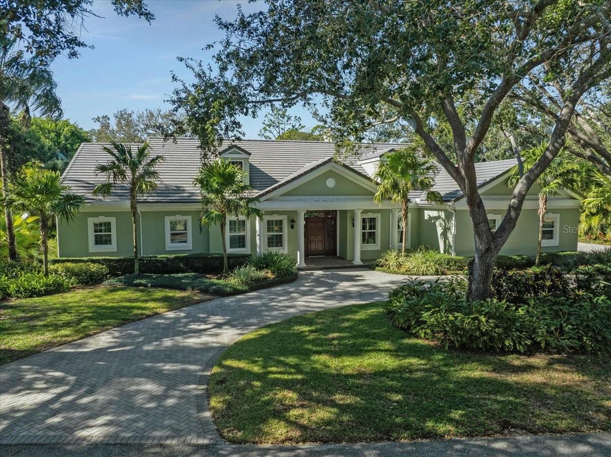 METICULOUSLY MAINTAINED AND THOUGHTFULLY UPDATED, THIS EXCEPTIONAL RESIDENCE IS PRIVATELY SITUATED ON A SERENE LOT WITH BEAUTIFUL GARDEN AND PRESERVE VIEWS. Located in Flood Zone “X” (no flood insurance required), the home is tucked behind the secure gates of the highly sought-after Bayside neighborhood within The Oaks Country Club, just steps from Little Sarasota Bay. The home offers 3 En Suite Bedrooms, 3 Full and 1 Half Baths. The Updated Kitchen features Quartz countertops, custom hardwood cabinetry, and premium appliances, including Sub-Zero and Wolf. A cozy family room with a wood-burning fireplace provides an inviting gathering space, while impressive Brazilian cherry hardwood flooring enhances the living and dining areas. The spacious primary suite includes a walk-in closet and a luxurious bath with dual vanities, a custom-tiled shower, and a soaking tub. Outdoor living is highlighted by a large screened and covered entertaining area, along with a stunning open-air pool overlooking the tranquil preserve. Additional features include a circular driveway and a peaceful, private setting. RECENT UPDATES include Hurricane IMPACT Windows (2019), HVAC (2021),  ROOF (2014), Flooring (2020), Etc. THE OAKS is a distinguished, 24hr Guarded, Country Club Community which boasts many accolades including: Platinum Club of America, Emerald Club of the World, Elite Distinguished Club of the World and One of America’s Healthiest Clubs - where amenities include Three Restaurants, Ballroom, Two 18-hole championship GOLF courses, award-winning RACQUETS program with 12 Har-Tru Hydro-Grid TENNIS courts, 4 PICKLEBALL Courts, wonderful CROQUET facility, state-of-the-art FITNESS center and junior Olympic, heated community SWIMMING POOL, Bocce, Basketball Court, Playground and more! The Oaks is just minutes from nationally ranked Pine View School, the Legacy Bike Trail, area Beaches and all that Gulf Coast living has to offer. Membership is required and there is NO WAITLIST for GOLF or SOCIAL Membership. **ENJOY THE 3D VIRTUAL TOUR and AERIAL VIDEO**
