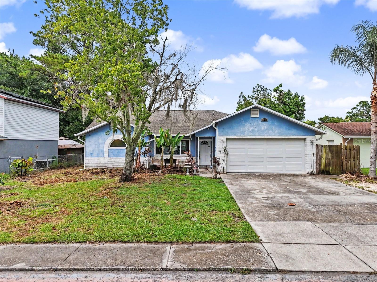 Discover the potential in this 2-bedroom, 2-bathroom home in the Meadows of New Port Richey featuring a desirable split floor plan, spacious living areas, and several valuable recent updates. Major improvements include a new 3.5-ton A/C system and completely redone ductwork (2025), storm-proof, energy-efficient, double-pane hurricane impact windows installed throughout the primary bedroom, guest bedroom, living room, and both bathrooms (2025), an AO Smith water heater, seamless gutters installed in June 2026 with transferable warranty, and a new garage door motor and components replaced in February 2026. Inside, the vaulted-ceiling living room creates an open feel and flows into the dining room and kitchen, which features a breakfast nook and a convenient high-top bar overlooking the living area. The primary suite offers vaulted ceilings, a walk-in closet, and an ensuite bathroom with dual sinks and a walk-in shower. The second bedroom also includes a spacious walk-in closet. A bonus room with approximately 100 square feet and its own ingress/egress (approximately 9'9" x 10') provides excellent flexibility and could potentially be converted into a third bedroom, home office, or hobby space. Additional features include a two-car garage with the garage refrigerator conveying, an avocado tree, a storage shed, and a unique built-in outdoor fire pit/oven in the backyard. With no HOA and no CDD fees, this property offers the opportunity to add your own personal touches while enjoying the benefits of its major system upgrades and convenient New Port Richey location.