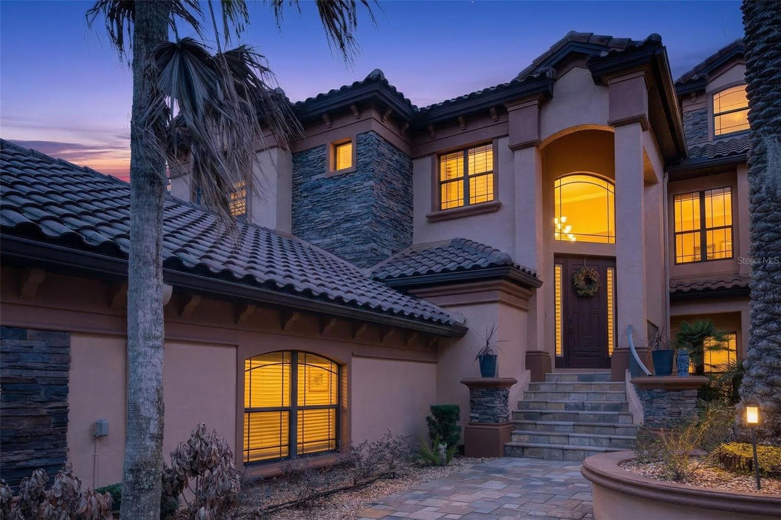 Welcome to 1105 W Pointe Vista in the highly sought-after Terra Vista community of Citrus Hills. This elegant two-story Mediterranean-style condominium offers 3 bedrooms, 2.5 bathrooms, a spacious office, a private elevator, and a two-car garage, perfectly positioned directly on the golf course with stunning sunset views. A grand staircase and dramatic crown molding create an impressive entrance, while real wood flooring and tile throughout provide both warmth and durability with no carpet. The expansive living room features large windows that frame sweeping golf course views, flowing seamlessly into the spacious dining room ideal for entertaining. The kitchen is well equipped with a gas stove, built-in oven, ample cabinetry, and a charming breakfast nook filled with natural light. Outdoor living is exceptional with two enclosed lanais overlooking the fairway—one enclosed with windows for year-round enjoyment and the other screened to capture the fresh Florida air and breathtaking sunsets. The primary suite offers a spa-like retreat with dual vanities, beautiful cabinetry, a large walk-in shower, and a Safe Step walk-in tub. Additional features include a private elevator providing easy access between floors, a tankless hot water heater, underground utilities, an oversized office, and elegant lighting throughout. Surrounded by mature palm trees and a paver entryway, the home’s Mediterranean architecture perfectly complements the upscale setting. Residents of Terra Vista at Citrus Hills enjoy access to exceptional amenities including community pools, restaurants, walking trails, dog parks, fitness facilities, and world-class golf, creating a true resort-style lifestyle just minutes from Crystal River and the Nature Coast.