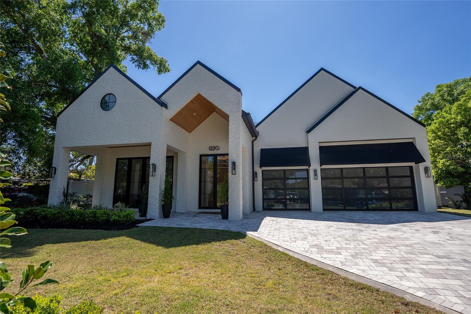 his Modern Contemporary home built by FG Schaub Custom Homes is 4,389 -SF under air plus a 434 SF transitional room creating 4823 SF of living all on one floor.. This urban retreat features 5 bedrooms, 5 en suite bathrooms, 2 half bathrooms, a formal dining room, and a 60’ by 9’ Gallery. The home is custom-designed to fit on the 14,360 SF lot. 


Built in 2023 this home has a meticulous design and high-quality fixtures. The 12’ ceilings are an inspiring accompaniment to the Anderson 10’ external double doors throughout the home. The Gallery acts as a grand entry and a space for art and entertainment. 


Adorned with 5 LED Chandiliers, the Gallery is a centerpiece of the home. The Formal Dining room sits off the Gallery, encased in glass, and the room can hold 12 dinner guests. The Formal Dining room includes a 200-bottle glass-enclosed wine wall. Through the Formal Dining room, you will find 10’ glass doors leading to the dining lanai featuring the custom-built stone firepit. The Brass and Glass Bar stands at the end of the Gallery. The centerpiece of your entertaining. 


The Chef’s Kitchen provides the space and equipment to indulge your culinary dreams. The island seats 8  allowing the entire family to enjoy the chef’s display. Thermador appliances include a 48” range top with flat grill, combined 48” double column refrigerator freezer and wall oven and microwave. The Butlers Pantry is adjacent to the walk-in Pantry and Formal Dining room, providing an ideal area for prepping and serving. 


The Great Room provides living space adjacent to both the bar, chef’s kitchen, and transitional room. The Great Room’s brick-accented main wall provides an ideal focal point for enjoying entertainment. Two sets of 10’ double doors lead from the Great Room to the Transitional Room. With the doors open the combined space measures over 40 feet in length. The Transitional Room is 434 SF in addition to the 4322 SF of under-air living space. 


The Transitional Room houses both the Summer Kitchen and Pool Bath. The Transitional Room provides a resort living feel as an automated screen separates the room from the expansive pool deck. The Primary Suite sits off the Great Room and has direct access to the pool deck through 10’ double doors which are draped with 12’ ceiling-mounted custom shear drapes. The sizable Primary suite allows room for a desk, bookcase, and exercise equipment, in addition to a king-size bed. The Primary Bathroom offers a large space including 72” freestanding tub, 7’ shower w/ 4’ wide bench, and single vanities. The Primary Bathroom leads to the Primary Dressing Room which provides ample wardrobe space.


Opposite the Primary Suite, we have the Guest Suite which is only accessible from the pool deck, providing an inlaw suite effect. The Guest Suite has 10’ double doors providing direct access to the pool deck. The Guest Suite Bathroom provides a roll-in shower to accommodate family members of all ages. Equipped with a Yale Lock keypad, the Guest Suite is accessible without having to enter the main home, perfect for visiting guests. The Pool Deck measures approximately 1600 SF with a sumptuous 38’ X 12’ (450 SF) heated swimming pool. Mature landscape adorns the perimeter of the backyard providing a true urban oasis feel.