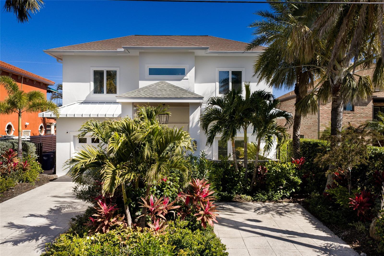 A MASTERPIECE OF MODERN COASTAL LUXURY SET DIRECTLY ON THE MANATEE RIVER AND JUST MINUTES FROM IMG ACADEMY! This extraordinary 5 bedroom, 4.5 bathroom waterfront estate offers over 6,000 square feet of impeccably curated living space, blending timeless architecture with refined coastal elegance and your own private WHITE SANDY BEACH!!!  Completely reimagined with the highest level of finishes (designer furnishings available for purchase seperately) this residence delivers a seamless transition into an elevated waterfront lifestyle defined by comfort, sophistication, and design. From the moment you arrive, the home’s striking curb appeal, lush tropical landscaping, and clean architectural lines create an unforgettable first impression. Inside, soaring vaulted ceilings and dramatic walls of glass frame breathtaking panoramic water views while filling the home with natural light. Intricate custom moldings, shiplap accents in the great room, and designer finishes throughout add warmth and architectural character. The main living space is both grand and inviting, centered around a sleek linear fireplace and custom built-ins. The gourmet kitchen is a true showpiece featuring double islands, quartz countertops, custom cabinetry, double ovens, and professional grade appliances. A spacious breakfast bar with statement pendant lighting and elegant gold accents creates the perfect setting for entertaining. The primary suite is privately positioned on the main level and a spa inspired bath offering dual vanities, a soaking tub, and a walk in shower. The first floor also includes an additional bedroom with en suite bath, a dedicated office, and a fully equipped wellness retreat featuring a gym with Tonal and Peloton, infrared sauna, and a cold plunge in the courtyard. Upstairs offers three additional bedrooms, two beautifully appointed bathrooms, and an expansive bonus room overlooking the main living area and capturing elevated river views. The outdoor living experience rivals a private resort. Expansive terraces, multiple lounging areas, and a stunning pool overlooking the open water create a setting designed for both relaxation and entertaining. A covered outdoor kitchen and dining space seamlessly extend the living area, allowing for effortless year round indoor outdoor living. The brand new dock is equally impressive, featuring Trex decking, a brand new 13,000 lb boat lift, fish cleaning station, firepit, and a covered seating area.  With NO BRIDGES, DEEP WATER and DIRECT ACCESS to the Gulf, this is a true boater’s paradise! Conveniently located just minutes from downtown Bradenton, this estate is near top-tier schools, including IMG ACADEMY, ST STEPHENS AND BRADENTON CHRISTIAN SCHOOL! Only minutes to the Gulf Beaches of Anna Maria Island, short distance to downtown St. Pete and the cultural & culinary arts of Sarasota. TRULY AN AMAZING LOCATION WITH EASY ACCESS TO SO MANY OPTIONS!