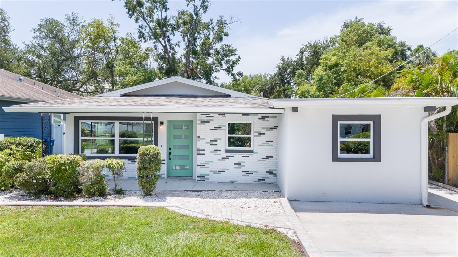 Searching for the combination of complete peace of mind and unparalleled convenience in Tampa? This turnkey 4BD/3BA mid-century block home is insurance-friendly, featuring a New Roof, HVAC, Windows, Doors and Electrical Panel. Minutes from Tampa International Airport and 15 minutes to Downtown, it is the ultimate opportunity offering modern comfort and a prime location.

Welcome to a beautifully remodelled mid-century modern residence updated in a modern style. Tucked into the quiet Lincoln Gardens neighborhood, an established community that is also undergoing an exciting transformation with new homes commanding up to $900,000. This is driven by being positioned close to high-end dining/shopping, easy access to travel, and major sports venues: Raymond James Stadium, the proposed Rays Stadium, and George Steinbrenner Field. 

Step inside to a bright interior lit by natural light designed for the rhythm of modern life. The interior features a refreshed kitchen with durable granite countertops, brand-new appliances, and wood cabinets. With four bedrooms and three full bathrooms, there is plenty of room for a growing household or a dedicated home office.

The amazing value in this home lies in its renewal. Every major big-ticket item has been taken care of: a brand-new Roof, new high-efficiency Windows and Doors, a new HVAC system, and a newly updated Electrical Panel. Along with new luxury vinyl plank flooring throughout plus fresh paint inside and out! You can move right in without the stress or expense of upcoming maintenance.

Outside, the generous lot features a large, securely fenced backyard shaded by mature trees. It is a fantastic canvas for outdoor entertaining, pet lovers, or a future pool. Directly beyond your property line sits the Loretta Ingraham Recreation Center, serving as an incredible, free lifestyle extension equipped with a pool, fitness room, and summer camps.

Positioned at the center of everything, you are a mere two minutes from the premier shopping and dining at International Plaza, five minutes from the terminal at Tampa International Airport, and fifteen minutes from downtown Tampa. Looking for white sand beaches? Clearwater Beach is an easy forty-minute drive away.

To complete this exceptional offering, the seller is providing a $15,000 Credit to use toward Closing Costs or a Rate Buy-Down (pending an acceptable offer), making this move-in-ready home an undeniable value in a rapidly rising neighborhood. Make an appointment today to tour this gem and make it yours!