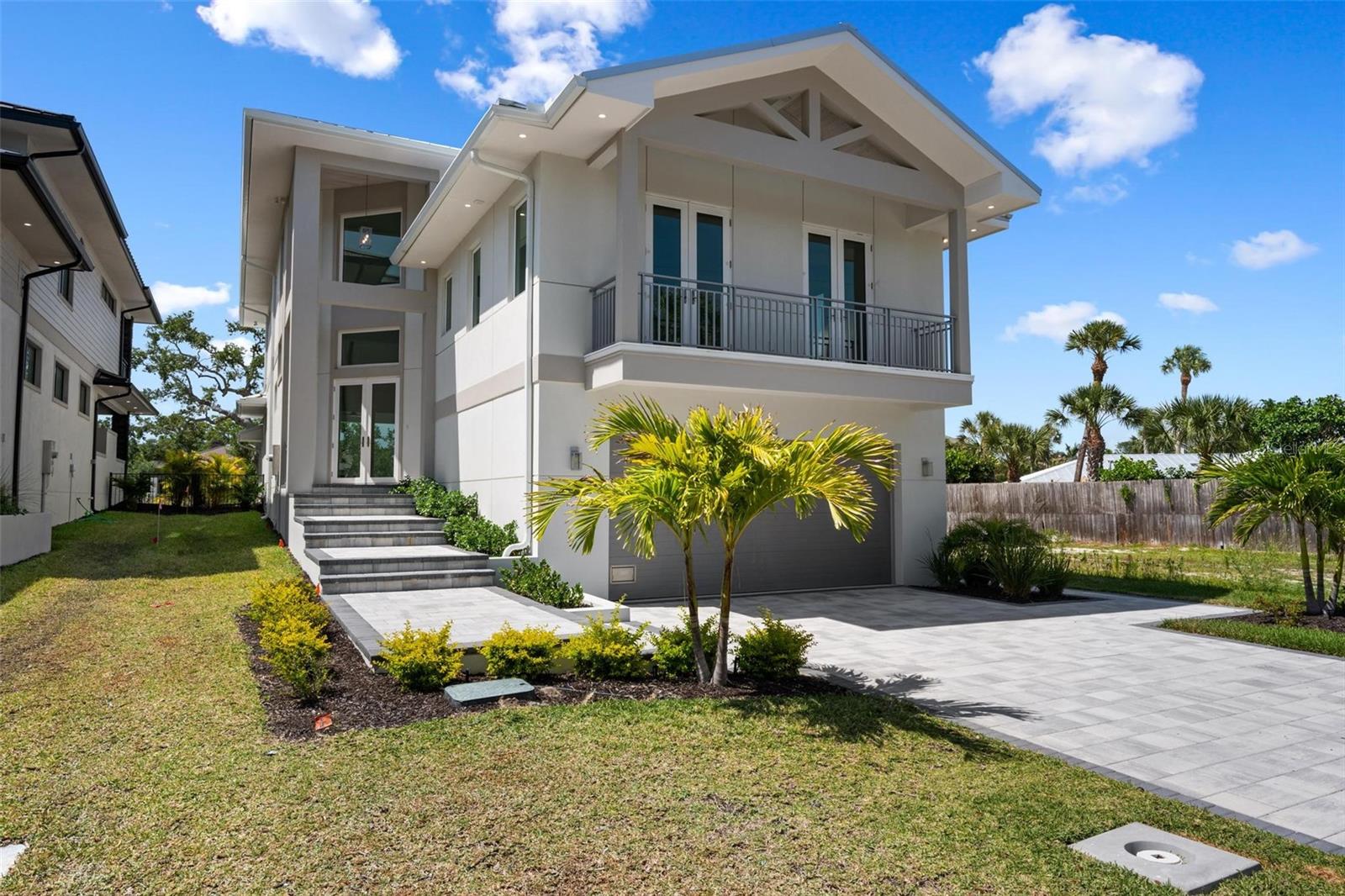 Virtually Staged. Under Construction. New Construction.  This stunning new waterfront home is perfectly positioned on Siesta Key’s Grand Canal, offering excellent boating water with quick access to Sarasota Bay. The residence features 4 bedrooms, 5 full baths (including a pool bath), and 1 half bath, along with two laundry rooms conveniently located on the first and third floors. A spacious third-floor loft provides a versatile living area just before entering the primary suite, ideal for a lounge, office, or private retreat. The open-concept family room and dining area showcase a Thermador-equipped kitchen and overlook a spectacular outdoor living space with an outdoor kitchen, pool with sun shelf, and custom deck leading directly to your private dock. Two balconies—one at the front of the home and one with sweeping waterfront views—enhance the indoor-outdoor lifestyle. Custom cabinetry throughout, quartzite countertops, and high-quality construction reflect attention to detail at every turn. Located just minutes from Siesta Key Beach, Siesta Village, and all of Sarasota’s amenities, this exceptional waterfront home is a rare opportunity—come see it for yourself.