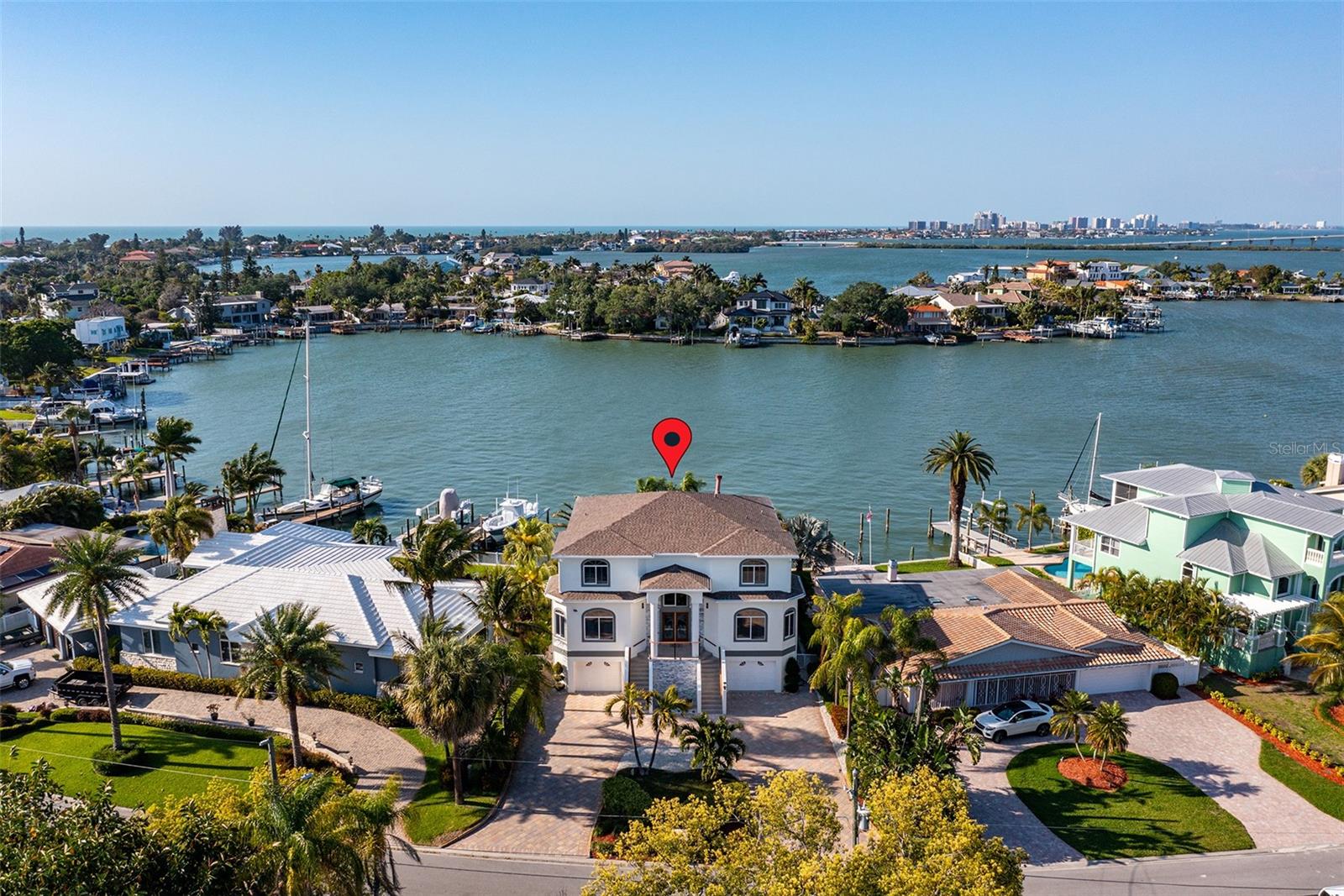 Experience the coastal elegance of this luxurious waterfront property. This stunning home, has been a popular short-term rental retreat and offers not just a residence but a gateway to the coveted beach lifestyle. 

As you approach the property, the sound of dolphins by the dock and the open views greet you. The home's exterior has been updated, featuring new roof, freshly painted façades, and professionally manicured landscaping. Step through the custom front door with etched glass detailing into a world where every day feels like a vacation.
The heated, saltwater pool area, invites you to relax and unwind under the warm Florida sun while enjoying views that stretch across the sparkling intercoastal waterway to the Belleair Beach Causeway and Sand Key of Clearwater Beach.

Enjoy the peace of mind knowing this home three-story haven is elevated and boasts seven bedrooms and six baths. Each bedroom serves as a private retreat, The interior brims with luxury, from the smart TVs and state-of-the-art home theatre with two rows of seating to the custom woodwork and high-end finishes throughout. 

The chef’s kitchen, with its gleaming quartz countertops and top-of-the-line appliances, is a culinary dream. Great for entertaining with large island in the kitchen and seating for 12 at custom table in kitchen overlooking pool and Inter-coastal.   Wall-to-wall windows/sliders and huge balcony off the living room.  Perfect for gatherings that spill out onto the balcony. The main living area features stunning electric fireplace and a grand entrance.

Main floor Master Suite with King bed, Ensuite bathroom, and private balcony overlooking heated saltwater pool and Inter-coastal views. Custom bunk bedroom with king/queen combo. Additional bedroom with 2 Queens on main floor with ensuite full bath.  Additional full bathroom and laundry room on the main floor. 

Master Bedroom on top floor with large balcony overlooking Inter-coastal with breathtaking views.  Huge walk-in closet, luxury ensuite with soaker tub and huge walk-in shower.  Three other bedrooms on top floor.  Private balconies overlooking pool and inter-coastal off 2 bedrooms. Imagine waking up to the sight of the intercoastal and gentle breezes, a daily luxury at this splendid home. 

The Lower level features large bar with fridge and  wet bar and game room.  Enjoy the Home theatre room with 2 levels of seating, led lighting and 85" TV.  You also get a Gym room with assorted equipment and adjoining bathroom with shower. 

Located near Tampa International Airport and St. Pete-Clearwater Intl Airport, ideally positioned for both travel and local exploration. The vibrant communities of Clearwater and St. Petersburg are mere miles away, offering endless dining, shopping, and cultural experiences.

 The lifestyle here is all about Florida living at it's best - soaking up the sun, whether it’s jet skiing, boating, or simply enjoying a sunset walk along the Gulf of Mexico. 

Strong rental income at over $346K in 2023 and over $220K for 2024. Already fully compliant with the new Indian Rocks Short-Term rental polices and procedures instituted last year.  Live here full time or rent and use it when you want. 

This not just a home; it’s a lifestyle choice for those who seek luxury, comfort, and the tranquil beauty of Florida’s Gulf Coast. Don't miss the opportunity to own this piece of paradise, where every day is a holiday and every window frames a stunning view.