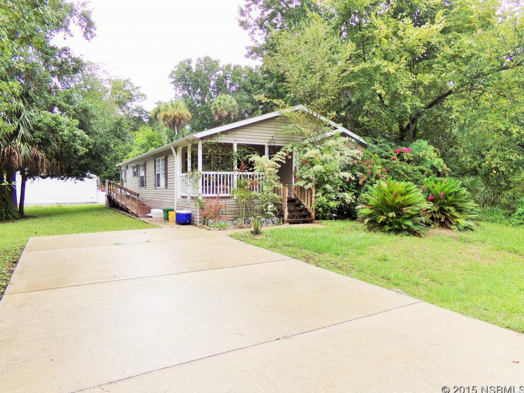 This super private, well-kept home will be your private oasis. With an amazing lot lined with citrus and beautiful blooming shade trees, this great home offers you the sought-after Florida lifestyle at its finest. This home boasts loads of natural light and lots of windows, vaulted ceilings and a fabulously spacious airy feel. Youâll love entertaining family and friends in the superbly spacious & bright eat-in kitchen that features beautiful cabinetry, lots of storage & counter space and fabulous bay windows in the dining nook. This home features a great open floor plan, spacious bedrooms, a beautiful built-in desk, and a fantastic covered porch overlooking the lush landscaped yard. Thereâs tons of great storage space with walk-in closets and an additional storage shed. The home also offers handicap accessible features, including exterior ramp & dual sinks plus walk-in shower in the master bath. ;Water: City