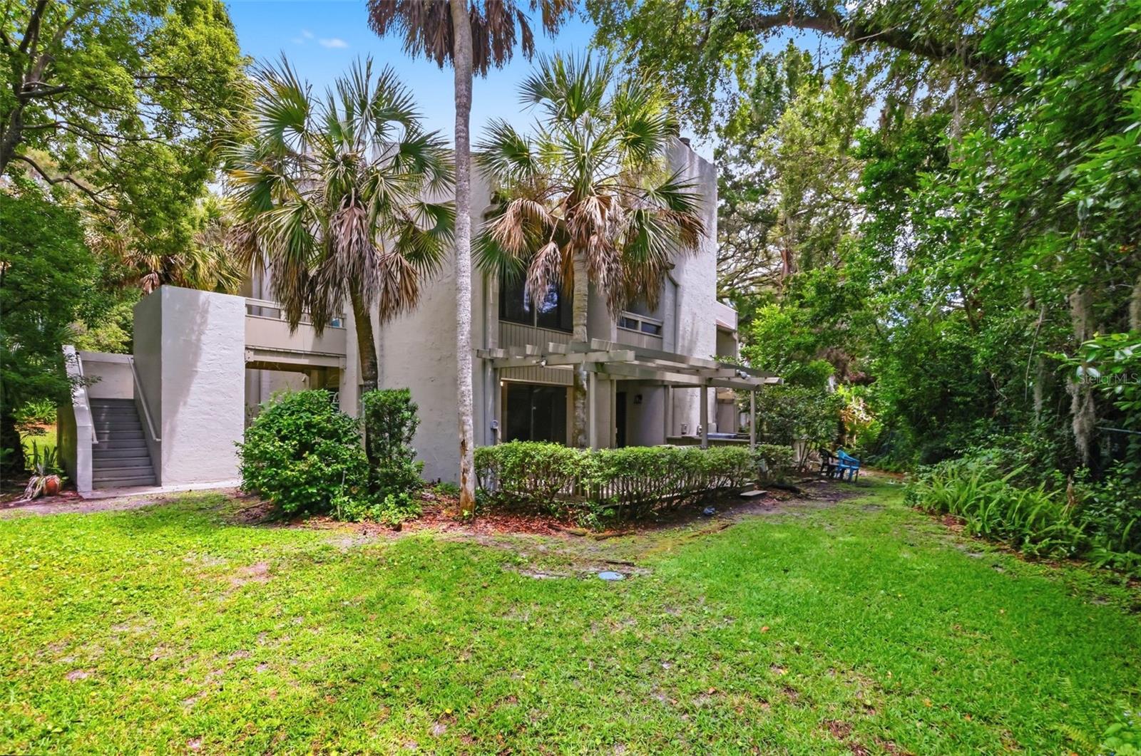 The Springs lifestyle at an exceptional value. Discover the perfect blend of comfort, character, and convenience in this ground-floor end-unit condo located in the highly sought-after gated community of Fairway Villas in Longwood. More than just a place to live, this home offers a lifestyle defined by privacy, security, and resort-style amenities. Inside, the open-concept layout is highlighted by soaring wood-beamed ceilings that bring warmth and architectural charm, blending rustic character with modern appeal. Sliding glass doors open to an expansive private deck surrounded by mature trees - an ideal setting for morning coffee, quiet evenings, or entertaining guests.

Thoughtful updates include refreshed counters, solid-surface finishes, and the ease of a primary suite conveniently located on the main floor. As an end unit, the home enjoys extra natural light and a greater sense of privacy than many other units. Living in The Springs means enjoying 24-hour gated security along with access to an impressive collection of amenities, including a private clubhouse, fitness center, tennis courts, community stables, and a natural spring for swimming. With all-inclusive maintenance fees covering water, exterior upkeep, 24/7 security, and recreational facilities, this property delivers outstanding value in one of Longwood’s most desirable communities. Opportunities like this in The Springs are rare - schedule your private showing and experience it for yourself.