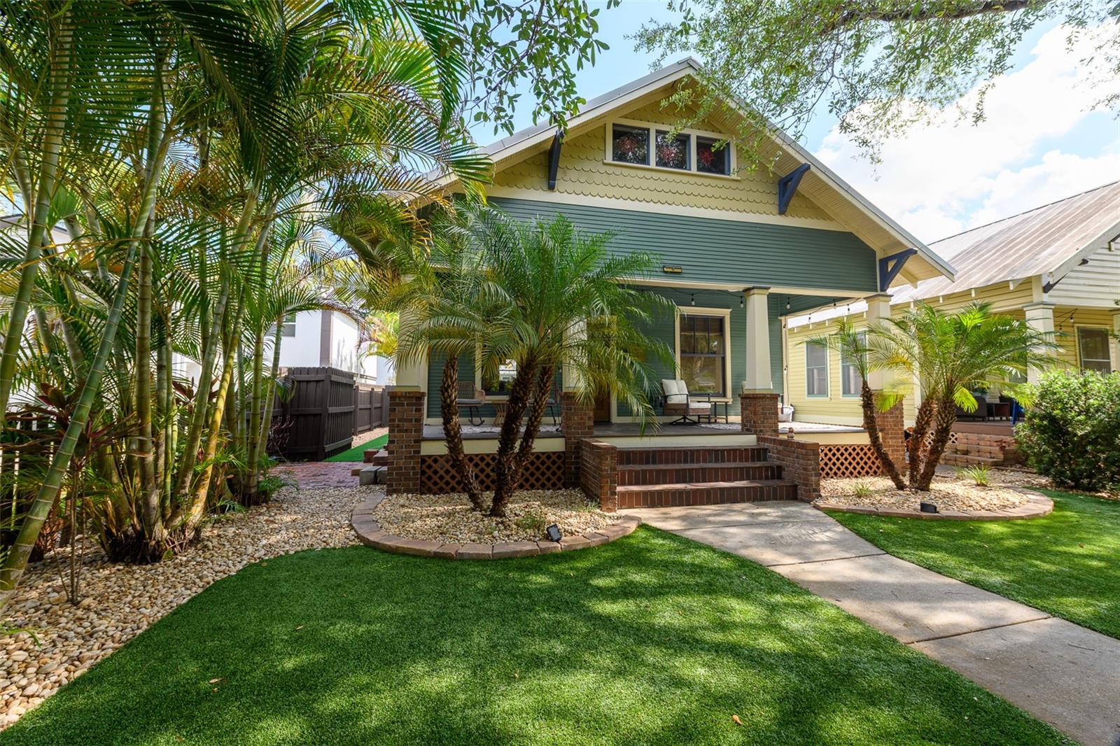 Rare opportunity to own a charming bungalow in the heart of Tampa Heights, blending the timeless character and craftsmanship of the past with the modern updates and conveniences of today. The main residence features 2 bedrooms and 2 bathrooms with an open-concept floor plan, soaring ceilings, rich hardwood floors, a cozy fireplace, and an updated kitchen designed for both everyday living and entertaining. A standout feature is the original heart pine built-in counter area that can be used as a dining table, thoughtfully preserved during the home's renovation. Adding to the property's appeal is a detached studio apartment complete with its own kitchen and bathroom—ideal as a guest suite, home office, fitness studio, creative space, or additional living quarters. Step outside to enjoy your private backyard oasis featuring a sparkling pool, low-maintenance artificial turf, and drip irrigation for easy landscape care. A spacious two-car garage and additional rear parking pad provide ample parking, a rare and highly sought-after feature in Tampa Heights. For those seeking multigenerational living or the opportunity to live alongside friends or family, the neighboring property at 316 E. Frances Ave is also available for purchase. This home is conveniently located just minutes from Downtown Tampa, the Riverwalk, restaurants, entertainment, and all the amenities this vibrant area has to offer, this is a truly unique property you won't want to miss.