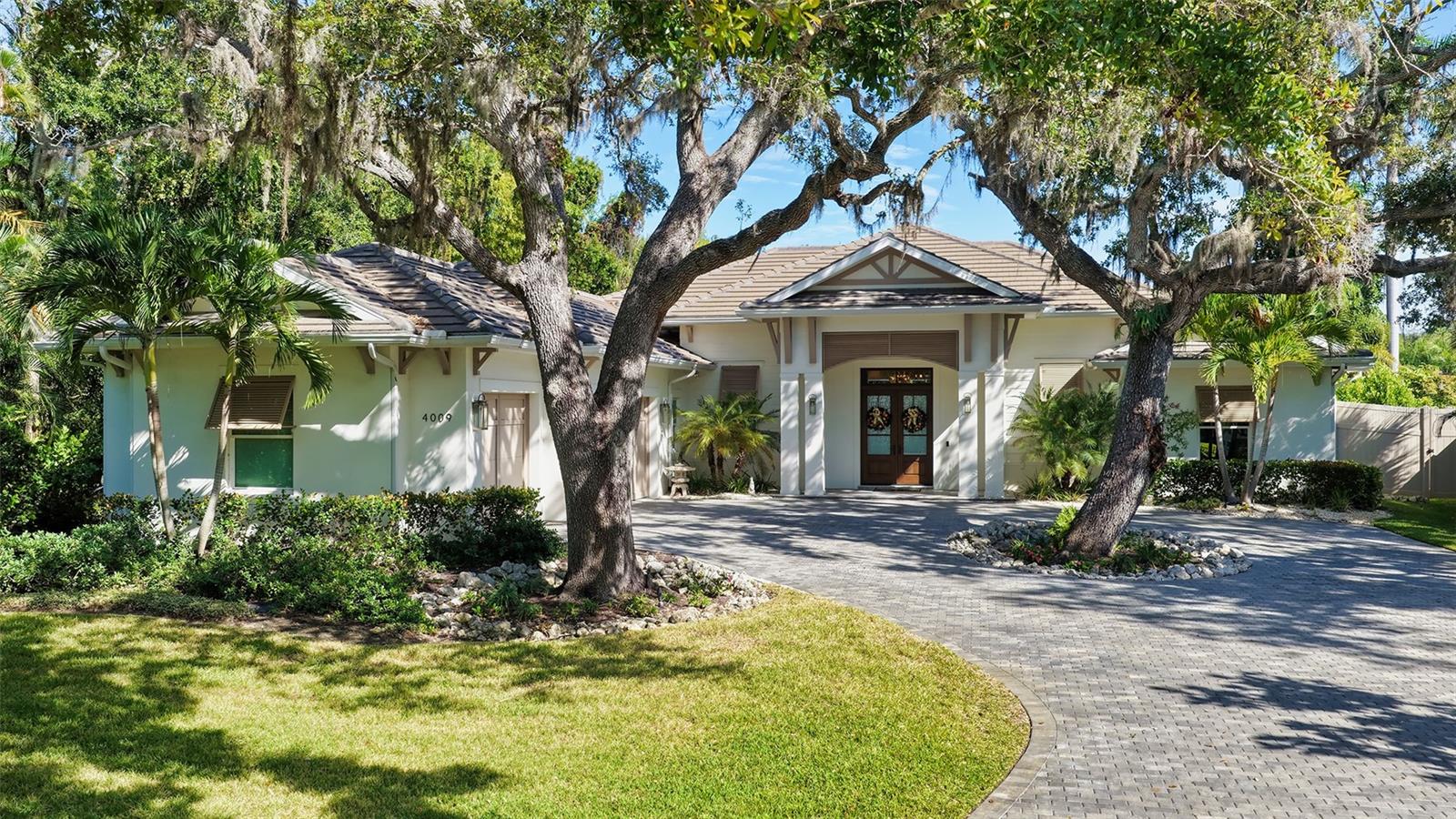 Exquisite home by Heritage Builder, situated on almost half an acre, in the most desirable area, West of the Trail, on a quiet canopy street. Lovely styling inspired by homes in the West Indies with the finest of interior finishes and memorable architectural details. A breathtaking view of a tropical paradise is seen from the Great Room and Kitchen, with sparkling pool and expansive area for entertaining including a beatiful covered area and outdoor kitchen. The owners suite features a formal entry vestibule, vaulted ceiling, his and her walk in closets, and a spacious bathroom with dual vanities. The open design kitchen has Chef's grade stainless steel appliances, full height backsplash and walk in pantry. Hurricane, impact rated, insulated, low E windows with vinyl frames, spray foam insulation and 8' solid core doors. This remarkable residence is more like a tropical resort on a "one of a kind" property. Located 10 minutes from downtown and the beaches.