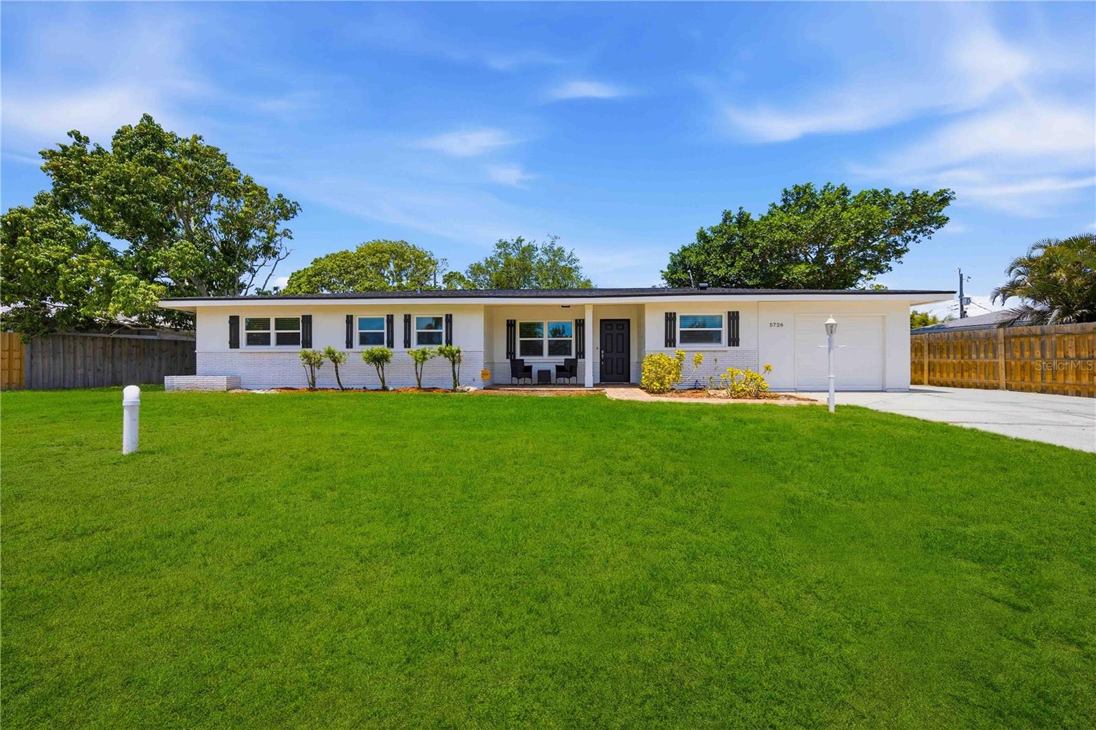 Exceptional location, extensive updates, and a private pool combine to make this Phillippi Gardens home a standout opportunity. Just minutes from Siesta Key Beach, downtown Sarasota, Sarasota Memorial Hospital, shopping, dining, and everyday conveniences, this property offers the ideal balance of accessibility and comfort. The costly improvements have already been completed, providing years of peace of mind. Triple-pane PGT impact-rated windows and a sliding glass door installed in 2018 deliver storm protection, energy efficiency, and potential insurance savings. The home's plumbing system was fully re-piped with PVC in 2018, and the septic system was replaced and connected to city sewer the same year—a rare and valuable upgrade. Additional improvements include a newer A/C system (2023), new water heater (2026), fresh interior and exterior paint (2026), updated flooring, and a newer screened pool enclosure. Inside, the thoughtfully designed three-bedroom, two-bath floor plan offers open living spaces that flow seamlessly from room to room, creating an inviting environment for both daily living and entertaining. Large windows and sliding glass doors bring in natural light while providing views of the outdoor living area. Step outside to a spacious screened lanai and pool area that serves as a private retreat for relaxing, dining, or gathering with family and friends. The generously sized backyard provides additional outdoor space with room to enjoy Florida's year-round sunshine. With no deed restrictions, a desirable school district, and major system upgrades already completed, this move-in-ready home offers exceptional value in one of Sarasota's most convenient locations.