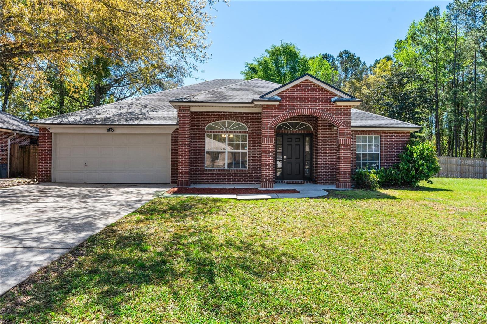 Freshly Painted interior and notable updates include WHOLE HOME WATER SOFTENER and New HVAC systems installed in 2022. SOLAR PANELS will be PAID OFF with accepted offer. Propane tank for Gas Stove, fireplace and water heater was filled by AmeriGas! BRICK home with NAS/Cecil Field close by with VA ASSUMABLE option. The timeless brick exudes curb appeal, inviting you into a thoughtfully designed interior. The spacious floor plan seamlessly connects the living areas, providing an ideal setting for both relaxation and entertaining. The well-appointed kitchen features modern appliances and ample counter space, catering to culinary enthusiasts who love GAS RANGE/STOVE especially. Primary bedroom offers a tranquil retreat with an en-suite bathroom, while three additional bedrooms provide flexibility for guests. The 4th could be a nonconforming bedroom, home office or flex space. For those cold evenings enjoy the gas fireplace and opportunity to host guests on the front porch or back patio..

Situated in a prime location with convenient access to Downtown, nearby shopping centers, grocery stores! Public Kayak launch is in close proximity to the home. ASSUMABLE RATE 5.5%. *Irrigation System does not work and is "AS IS", Washer/Dryer convey "AS IS" and seller will not repair those items.