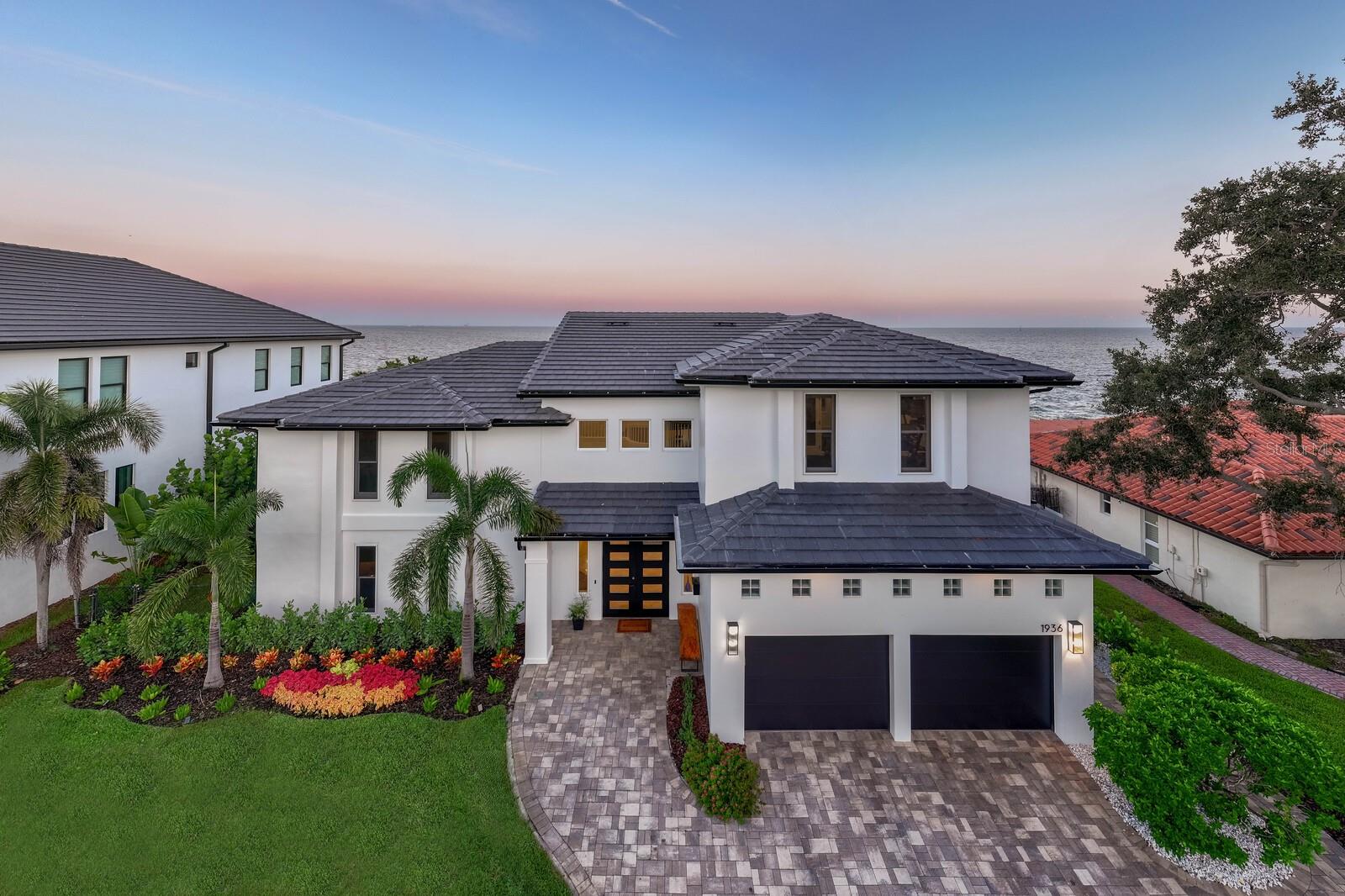 Exquisite Move-In-Ready Waterfront Masterpiece! Elevated and no flooding in recent storms, this house redefines St. Petersburg waterfront luxury. This contemporary gem blends bold architectural design with refined, inviting interiors, showcasing 90ft of panoramic open-water views. Features 4 upstairs bedrooms, including a luxurious primary suite with unrivaled water vistas, plus 2 first-floor bedrooms (one perfect as a guest or secondary primary suite). The outdoor haven boasts a brand-new 2025 dock, refreshed pool and decking, new 2025 outdoor grill, updated seawall, new 2025 slate roof, gutters, and soffits, and meticulously curated landscaping. Inside, expansive windows flood open-concept spaces with natural light, highlighting sleek contemporary finishes and effortless indoor-outdoor flow. Equipped with dual 2020 Trane HVAC systems and two 2017 tankless water heaters for ultimate efficiency. Just minutes from vibrant downtown St. Petersburg, this home epitomizes sophisticated St. Pete waterfront living. Ready for you to move in and enjoy the Florida lifestyle!