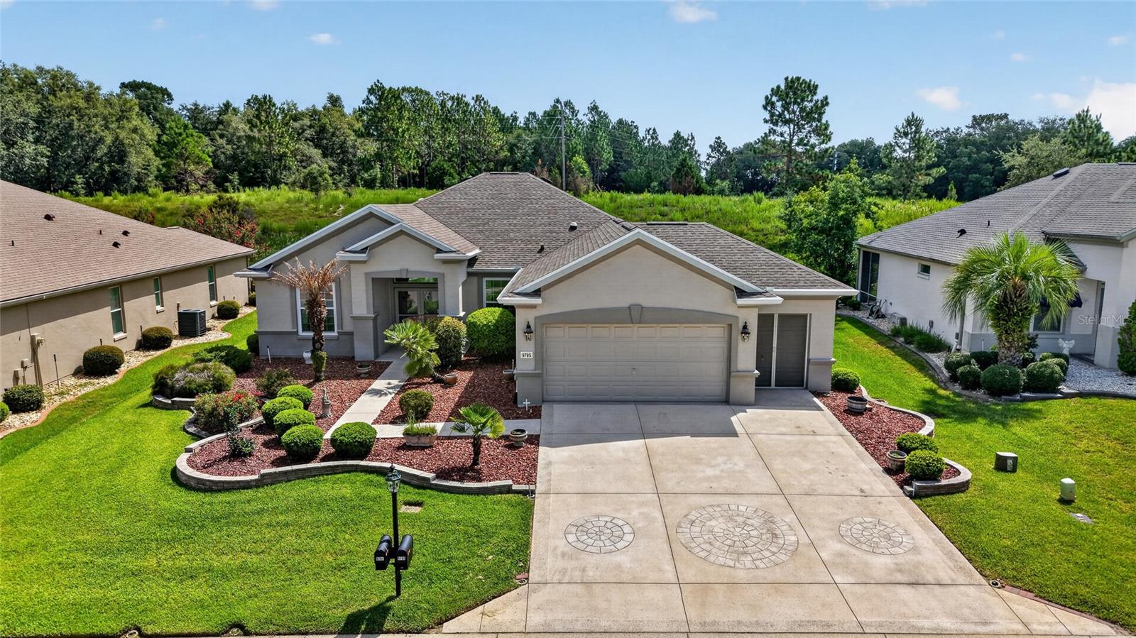 First time on the market and offered by its original owner, this Hanover is located on the highest point of Hampton Hills and comes turnkey with a golf cart—just bring your linens. Set on the Preserve with no backyard neighbors, the home features a designer-painted and textured driveway, walkway, and front porch, along with double front doors, hacienda-style walls, and attractive landscaping. Inside, you’ll find a beautifully maintained home with pull-out kitchen cabinets, newer appliances, crown molding throughout, and solar tubes in the Great Room, Kitchen and Laundry Room that fill the space with natural light. The enclosed lanai and backyard patio offer additional places to relax. The home has been re-piped, and the second bedroom has direct access to the guest bathroom. The extended garage includes a tandem golf cart garage, workbench, portable generator, and ample cabinet storage. Major updates include a roof replaced in 2021, HVAC and water heater replaced in 2017, and new windows installed in 2020. The seller is also offering a one-year home warranty, and a transferable termite bond is included.  Located in the beautiful, tree-canopied Del Webb Spruce Creek Golf and Country Club, this 55+ community offers outstanding amenities and four 9-hole golf courses. Conveniently situated just north of The Villages and south of Ocala, the home is close to fine dining, shopping, and entertainment.  Schedule your appointment today to see this wonderful home.