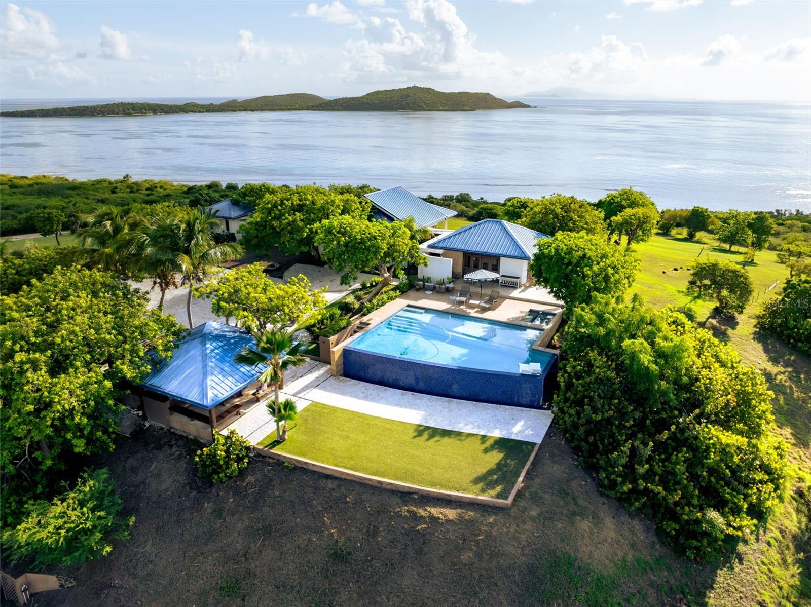 Introducing Villa Azure: A Rare Caribbean Estate for the Ultimate Private Retreat Getaway. 

Perched atop 22.05 acres in the prestigious North View Estates of Culebra, Puerto Rico, Villa Azure is a private sanctuary designed for the discerning buyer seeking a luxurious retreat getaway, unrivaled privacy, and meaningful investment potential. As one of the most expansive privately held properties on the island, this estate offers a rare opportunity to own a turn-key Caribbean haven within U.S. territory, no passport required.

Nestled on Culebra, an unspoiled paradise just off Puerto Rico’s eastern coast, Villa Azure is surrounded by protected nature reserves and vibrant marine life. Home to the world-famous Playa Flamenco, consistently ranked among the best beaches in the world, Culebra delivers unmatched natural beauty, ecological preservation, and a laid-back island lifestyle.

With panoramic views of nearby Culebrita and St. Thomas, and access to some of the Caribbean’s most pristine waters, Villa Azure offers a rare fusion of refined island living and complete seclusion.

Designed for those who appreciate both refined architecture and untamed natural beauty, the estate features a total of 7-bedrooms, 7 full-bathrooms, and 2 half-bathrooms across over 4,000 square feet of interior living space. Breezy, open-plan interiors connect effortlessly to ocean-facing terraces, capturing panoramic views of the turquoise waters.
A separate, solar-powered 2-bedroom guesthouse provides added privacy for guests or staff and enhances the estate’s self-sufficiency and discretion. From the infinity-edge pool to the shaded outdoor pavilion, every element is thoughtfully designed to inspire relaxation, privacy, and connection to the surrounding environment.

Essential infrastructure, including a whole-home generator, water cisterns, and internet connectivity, ensures all-season comfort and convenience. As part of the exclusive North View community, owners also enjoy access to a private dock, perfect for boating, island-hopping, and exploring the Caribbean by water.

Villa Azure is more than a home; it’s a strategic asset with long-term value and vision. With over 22 acres of developable land in a protected enclave, the estate presents exceptional potential for future expansion or strategic investment. Whether as a private estate or a boutique hospitality concept, it also offers high-end luxury short-term rental (STR) opportunities, ideal for investors seeking both passive income and long-term asset growth.

Puerto Rico’s attractive tax incentives and U.S. jurisdiction further enhance the property’s value proposition, offering a strategic, tax-advantaged investment opportunity in one of the Caribbean’s most exclusive destinations.

For the buyer who values exclusivity, privacy, and long-term upside, Villa Azure delivers a lifestyle as rare as the land it occupies, a true high-end retreat getaway in the heart of the Caribbean.