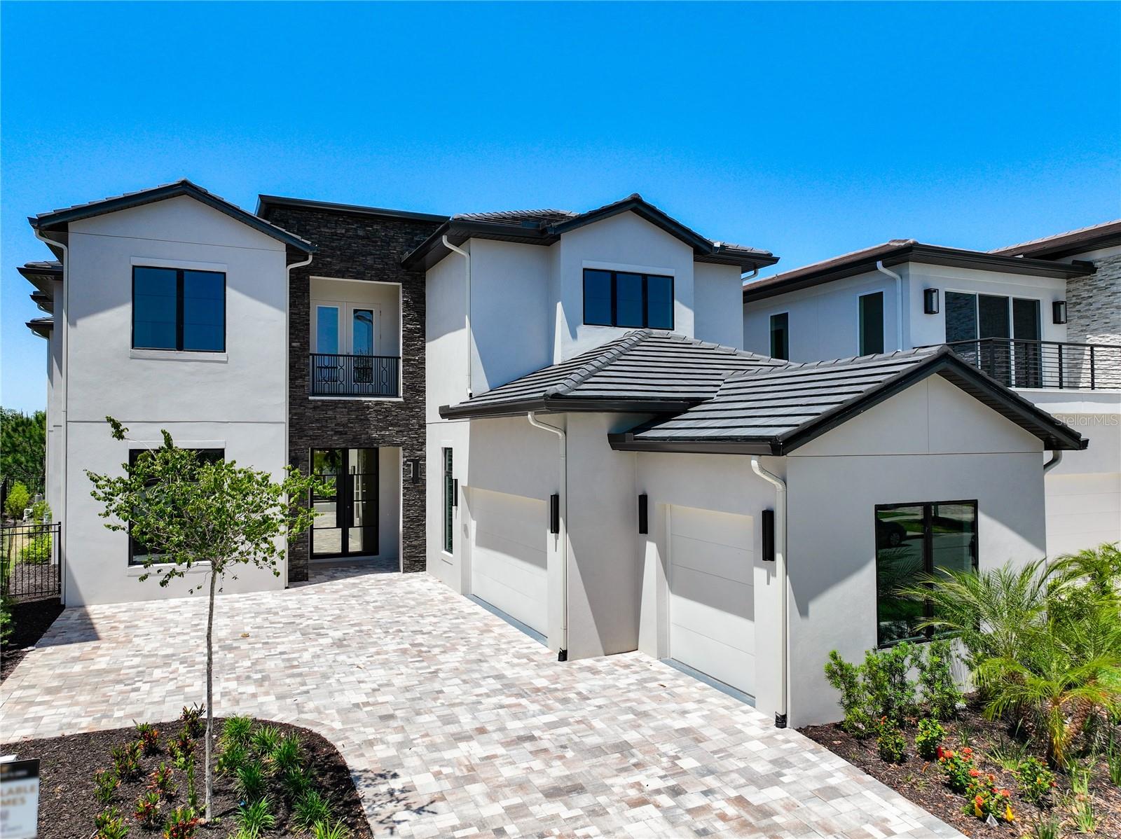 SELLER MOTIVATED, JUST REDUCED BY 75K, Beautiful New Home on an oversized homesite behind the gates of the Bear's Den and features 7 bedrooms with 7 full baths and 2 half baths, game room, movie theater, pool with spill over spa and summer kitchen.  Gourmet kitchen, two islands with quartz countertops and a huge walk-in pantry and plenty of storage throughout the home.  Whether you want to use your home as 2nd home for family and friends or a luxury rental property, this home offers many options.  The Interior architectural details stand out on this home. Two first floor en-suites for guests or extended family. Porcelain flooring in all common areas on the first level, wood on the 2nd floor stairs and hallway. The second Floor includes a game room and a movie theater for entertaining with 5 en-suite bedrooms.  Watch the Sunsets on the balcony or relax in the spa in the evening.   Reunion Resort is a World Class destination just 10 minutes away from Walt Disney World with access to 3 signature golf courses, 6 tennis courts, pickle ball courts, a water park with lazy river, as well as 6 restaurants within the community. The impressive clubhouse at Bears Den features a restaurant, pro shop, men's and women's locker rooms. Call today to schedule a private showing. This is a Jack Nicklaus Licensed community with Reunion Gold or Platinum Membership available.